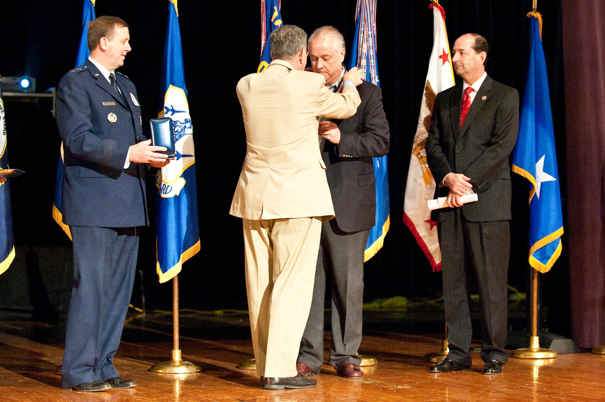 Dennis M. McCarthy, assistant secretary of defense for Reserve Affairs (left), presents State Sen. David L. Williams with a Department of Defense Centers of Influence Award during a ceremony held April 17, 2010 at Louisville Male High School in Louisville, Ky. The award recognizes individuals who have been especially supportive of military service members since Sept. 11, 2001. (U.S. Air Force photo/Maj. Dale Greer)