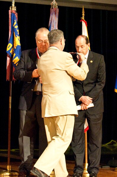 Dennis M. McCarthy, assistant secretary of defense for Reserve Affairs (center), presents State Rep. Rocky Adkins with a Department of Defense Centers of Influence Award during a ceremony held April 17, 2010 at Louisville Male High School in Louisville, Ky. The award recognizes individuals who have been especially supportive of military service members since Sept. 11, 2001. (U.S. Air Force photo/Maj. Dale Greer)