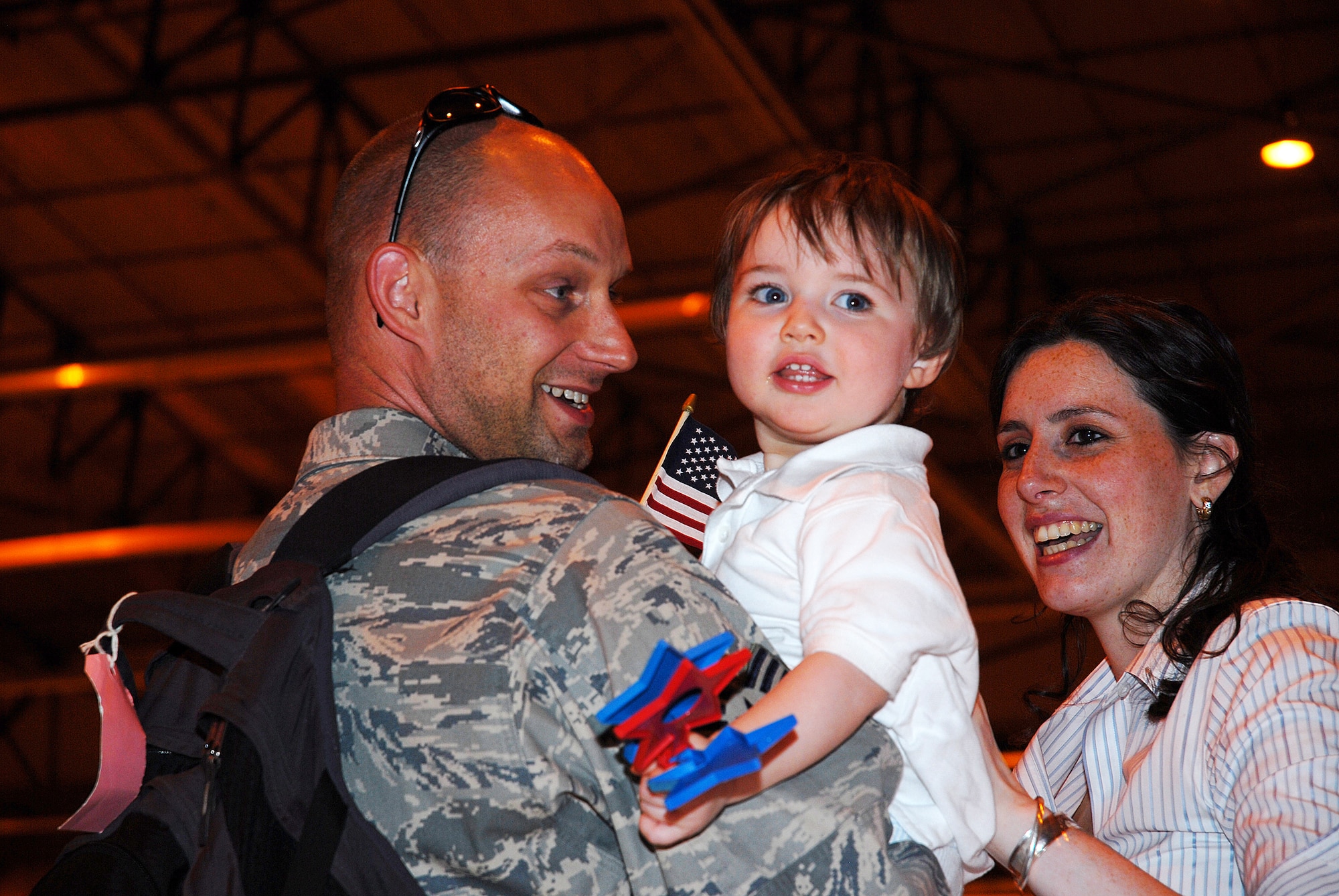 Tech Sgt. Jeff Johnson, 201 FS Weapons Specialist, receives a warm welcome home from girlfriend Deonne O'Connor and her son, Tristan; the Airman returns from an AEF rotation in support of Operation Iraqi Freedom, April 6. (U.S. Air Force photo by Tech Sgt. Tyrell Heaton/Released)