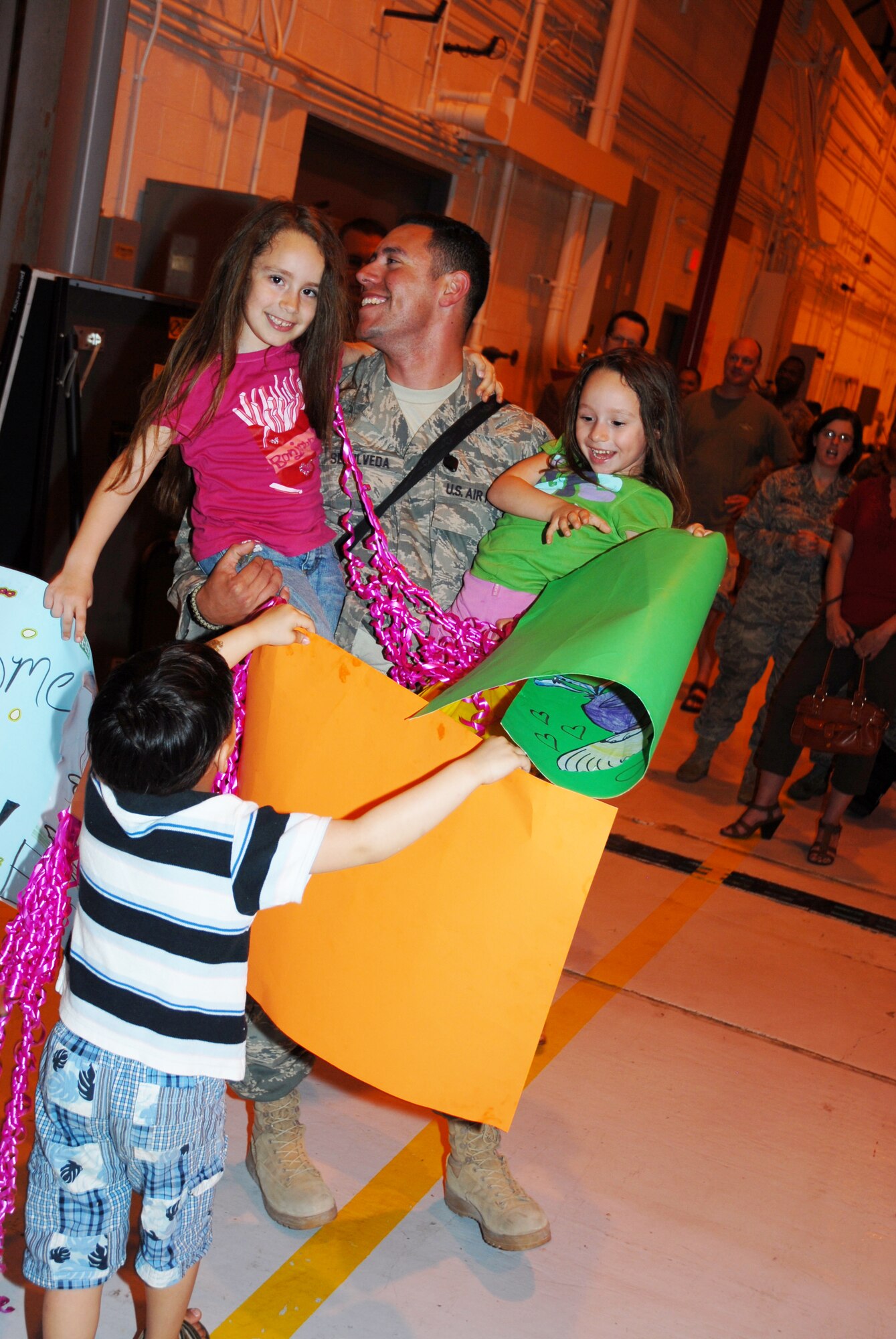 Tech Sgt. Elias Sepulveda, 113 LRS, shares the joy of coming home with daughters Emily and Emma upon his retrun from an AEF deployment to Iraq, April 6. (U.S. Air Force photo by Tech Sgt. Tyrell Heaton/Released)