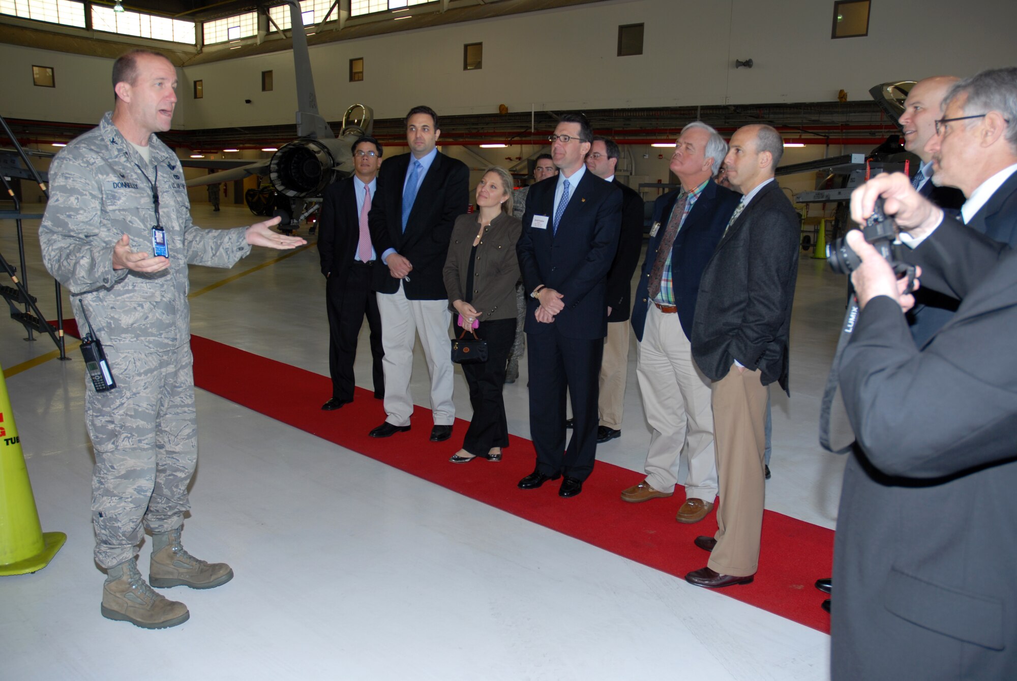 Col. Andrew Donnelly, 113 OG Commander, welcomes civic leaders from The Kaplan Public Service Foundation in the 113 AW hangar, April 22. (U.S. Air Force photo by Tech Sgt. Tyrell Heaton/Released)