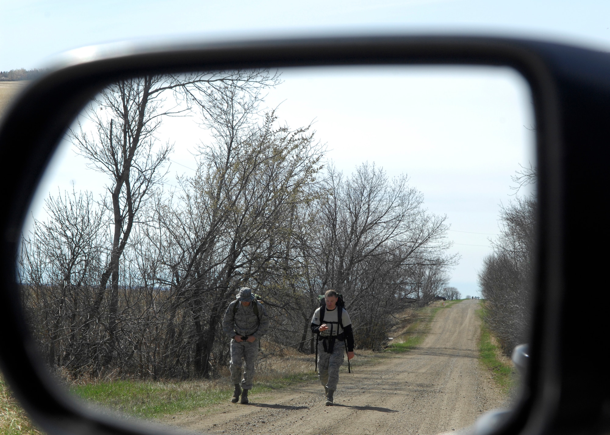 MINOT, N.D. -- Members of Team Minot march on with 50-pound ruck sacks on a warm and sunny day during the first-ever Wounded Warrior Project Awareness Ruck March here April 24. Marathon fees were waived for anyone participating in the march. The march started and ended at the Minot YMCA. Marathon fees were waived for anyone participating in the march. (U.S. Air Force photo by Senior Airman Ashley N. Avecilla)