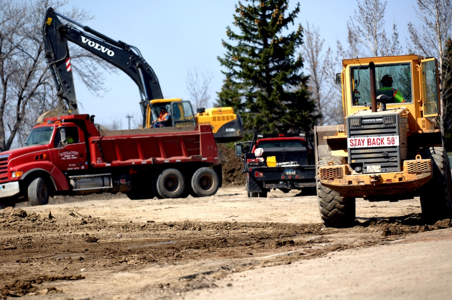 MINOT AIR FORCE BASE, N.D. -- Construction workers tear down what’s left of a building foundation on Linden loop here April 20. Base workers are demolishing many of the older homes in base housing to make way for new homes in the future.  (U.S. Air Force photo by Airman 1st Class Aaron-Forrest Wainwright) 
