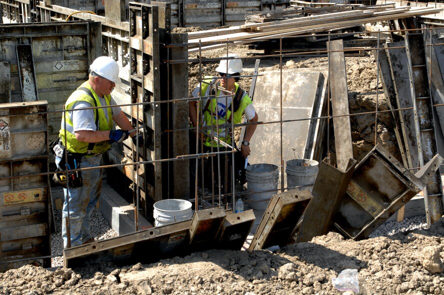 MINOT AIR FORCE BASE, N.D. -- Construction workers Gary Roberts and John Rehak tear down what’s left of a building foundation on Linden Loop here April 20. Base workers are demolishing many of the older homes in base housing to make way for new homes in the future.  (U.S. Air Force photo by Airman 1st Class Aaron-Forrest Wainwright) 