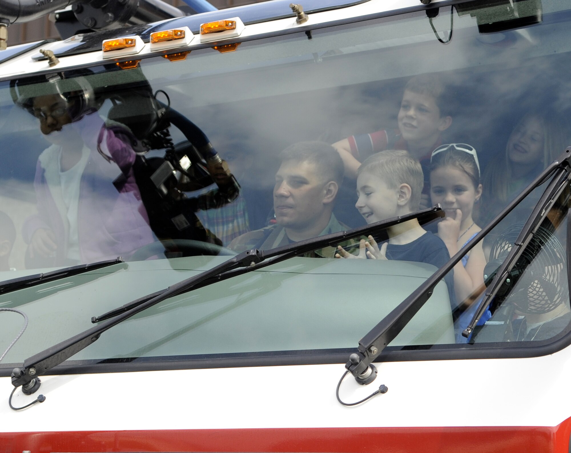 Children enjoy a fire engine demonstration at the installation fire department April 22 in honor of Bring Your Child to Work Day. Parents and their children visited a KC-10 aircraft, the fire department, Wacky World playground and military working dogs at Joint Base McGuire-Dix-Lakehurst. (U.S. Air Force photo/Carlos Cintron)