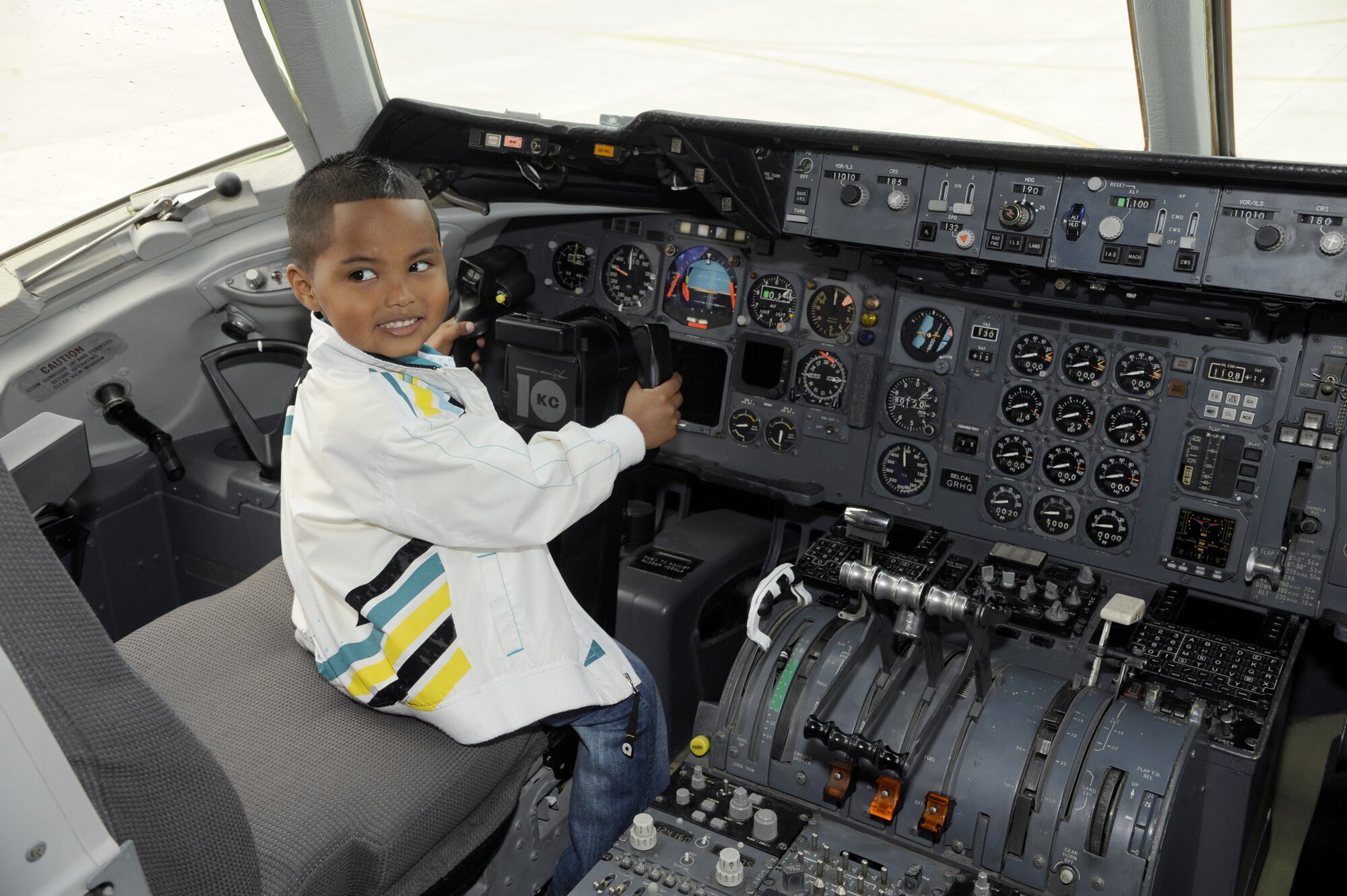 Uziel Alache, 4, son of Staff Sgt. Ibetly Alache, 514th Force Support Squadron, pretends to be the pilot of a KC-10 Extender. The KC-10 was just one stop during a tour in honor of the 514th Air Mobility Wing's Bring Your Child to Work Day April 22. Parents and their children also visited the fire department, Wacky World and military working dogs here. (U.S. Air Force photo/Carlos Cintron)