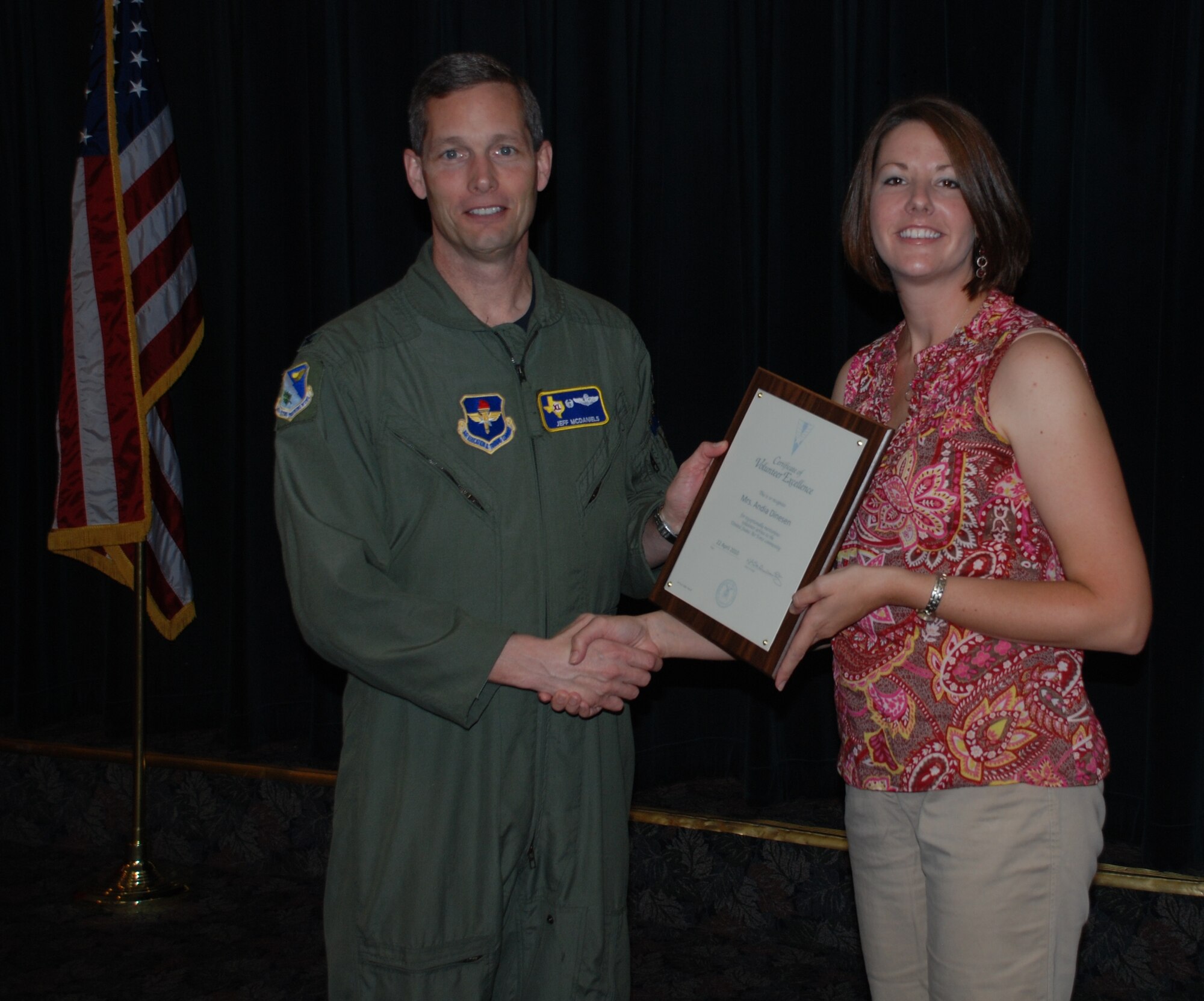 LAUGHLIN AIR FORCE BASE, Texas – Mrs. Andia Dinesen, wife of Capt. Ian Dinesen, 47th Security Forces Squadron commander, poses with Col. Jeffrey McDaniels, 47th Flying Training Wing commander, after being named Laughlin’s volunteer of the year. Laughlin members were recognized for donating more than 3,697 hours of their time saving the Air Force more than $77,000. (U.S. Air Force photo by Airman 1st Class Blake Mize)