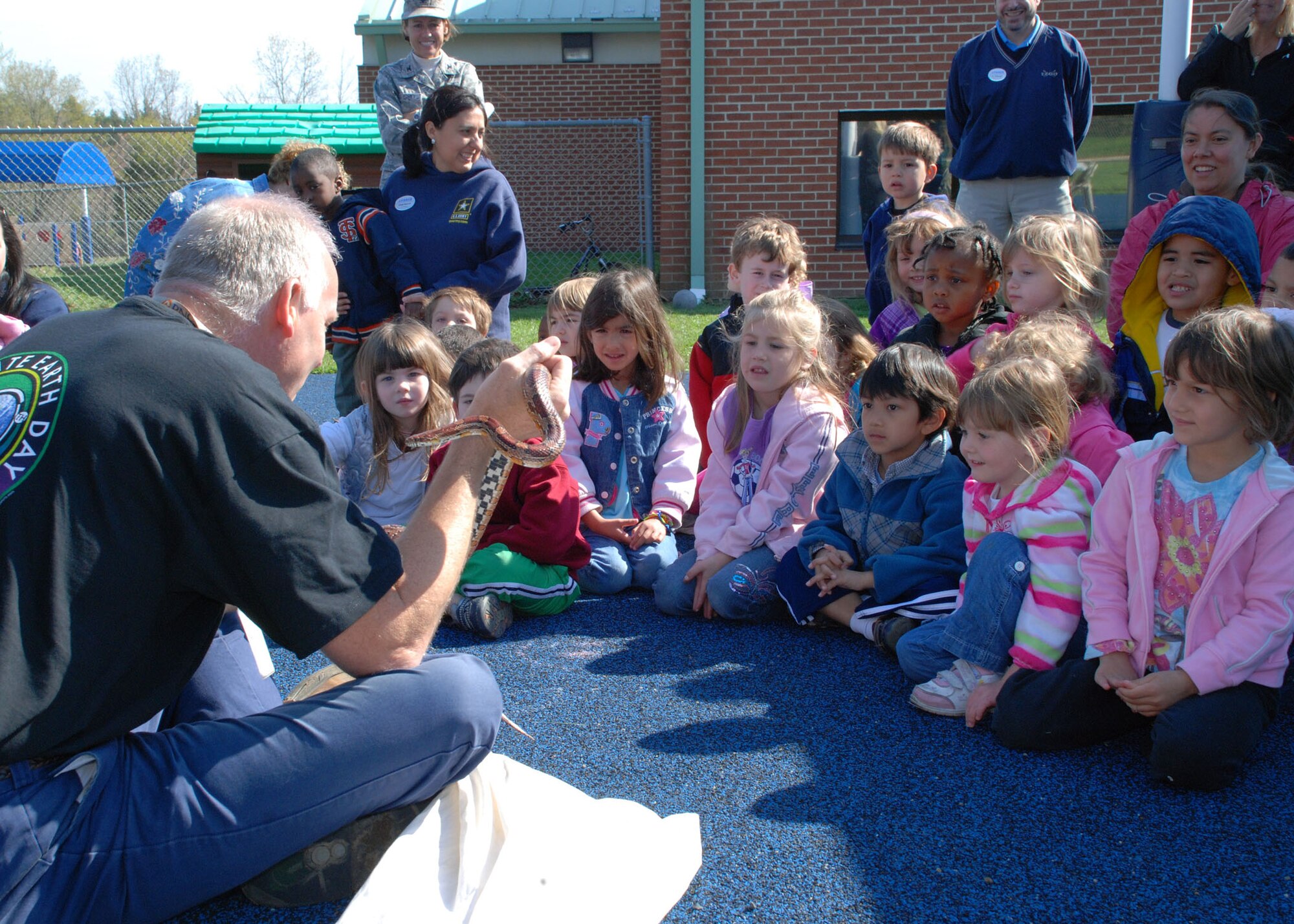 John Joyce, the natural resources officer at Lakehurst, introduces a corn snake to children of the Child Development Center here April 15 during an Earth Day celebration.Earth Day was celebrated throughout April across Joint Base McGuire-Dix-Lakehurst. (U.S. Navy photo/Sherri Jacobs)