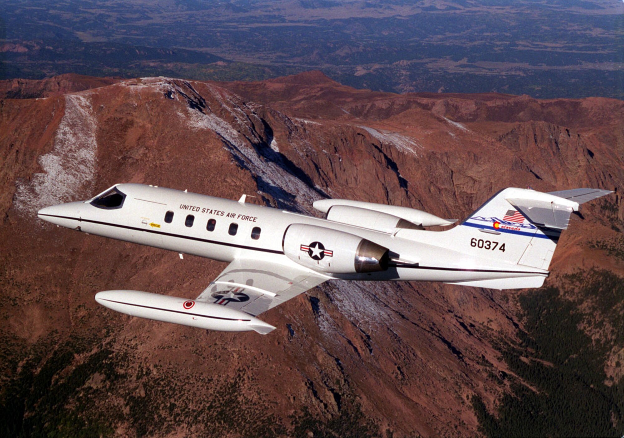 A C-21 jet from the 200th Airlift Squadron, Colorado Air National Guard, flies over Pikes Peak, the most visited mountain in North America.  Pikes Peak  forms a stunning backdrop for Colorado Springs at an altitude of 14,110 feet above sea level.
