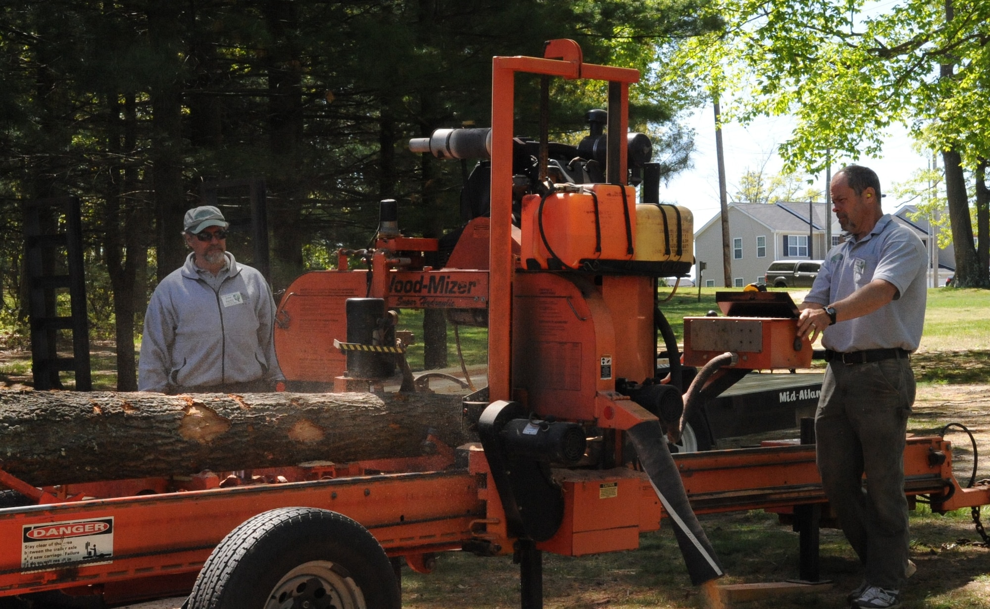 John Burkle and Bob Meierjurgen, New Jersey Forestry Service, demonstrate forestry in action during an Earth Day celebration here April 24. One of the goals of Earth Day is to educate the community on how humans interact with the environment and the  importance of taking care of our world. (U.S. Air Force photo/2nd. Lt Carolyn Glover).