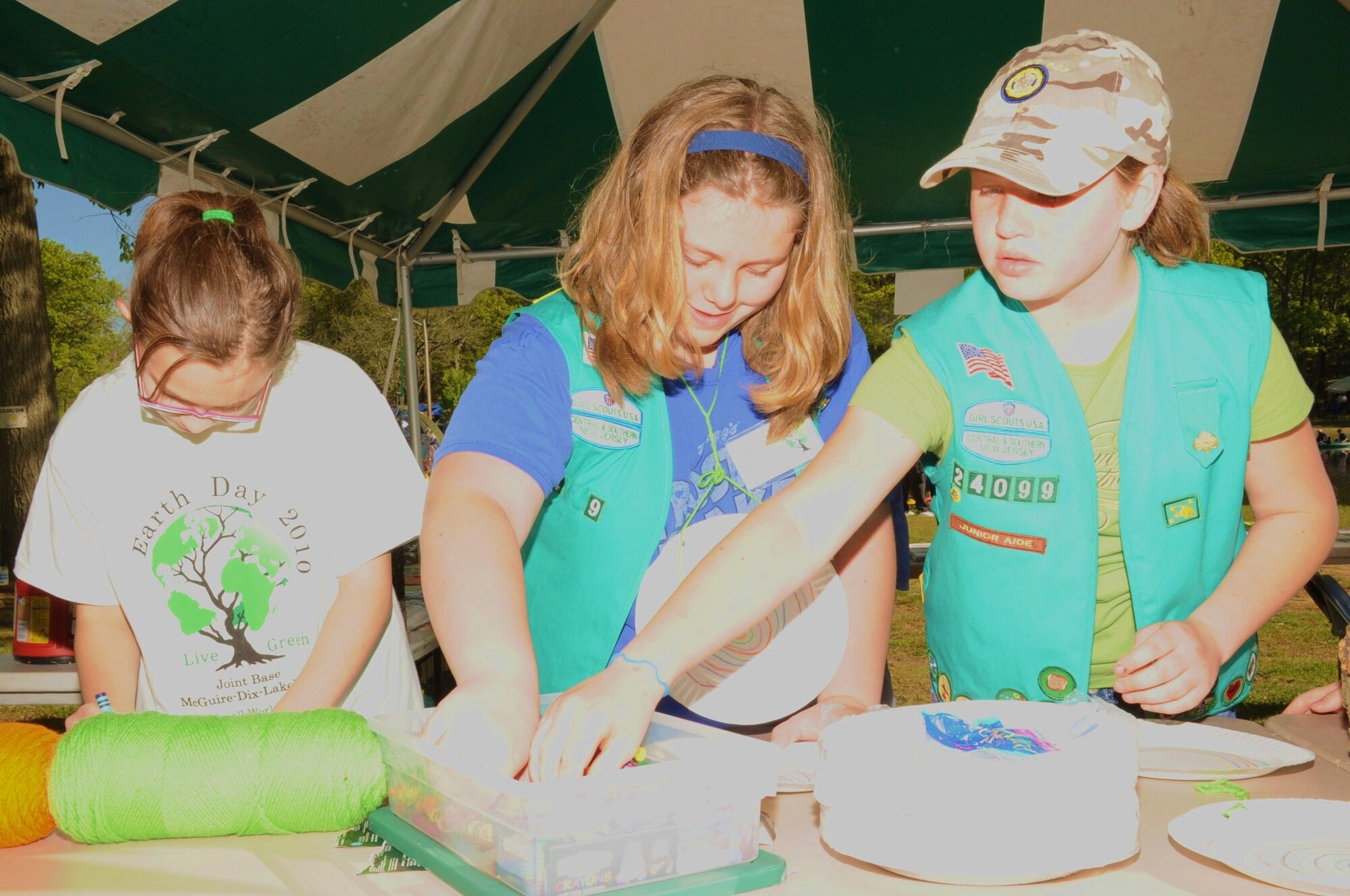 Ginny Titsworth, daughter of Maj. Guy Titsworth, 99th Regional Support Command, Amanda Gallagher, daughter of Air Force Master Sgt. (Ret.) Danny Gallagher and Kennedy Sherman, daugher of Tech Sgt. Jeff Sherman, 305th Maintenance Squadron, make tree cookies in celebration of Earth Day April 23. The girls belong to Girl Scout Troop 24099. (U.S. Air Force photo/2nd. Lt. Carolyn Glover)