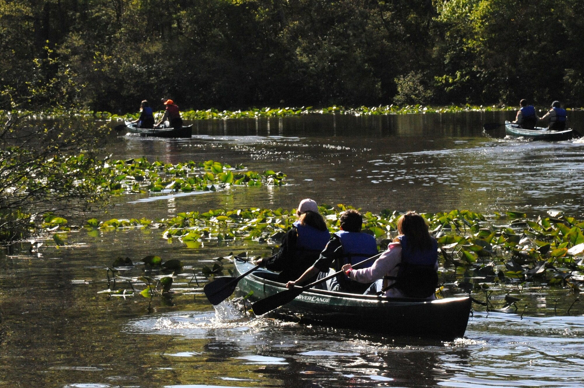 Joint Base McGuire-Dix-Lakehurst community members canoe across Laurel Pond on Earth Day April 24 here. Earth Day involved various activities and demonstrations encouraging attendees to learn more about the environment. (U.S. Air Force photo/2nd. Lt. Carolyn Glover)