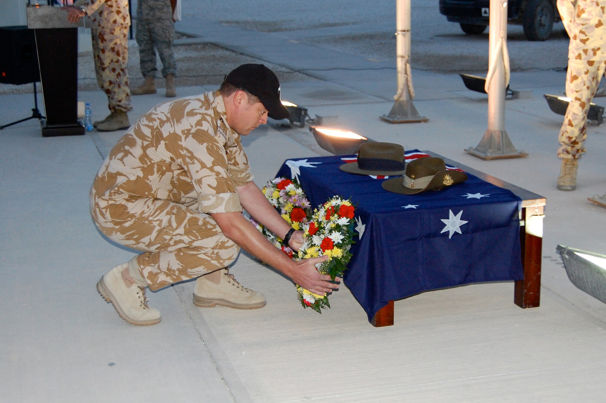 Squadron Leader Daniel Hunt, Royal New Zealand Air Force, lays a wreath at the Australian and New Zealand Army Corps Day dawn service April 25, 2010, in honor of fallen heroes. (U.S. Air Force photo/Maj. Chad Steffey/released)