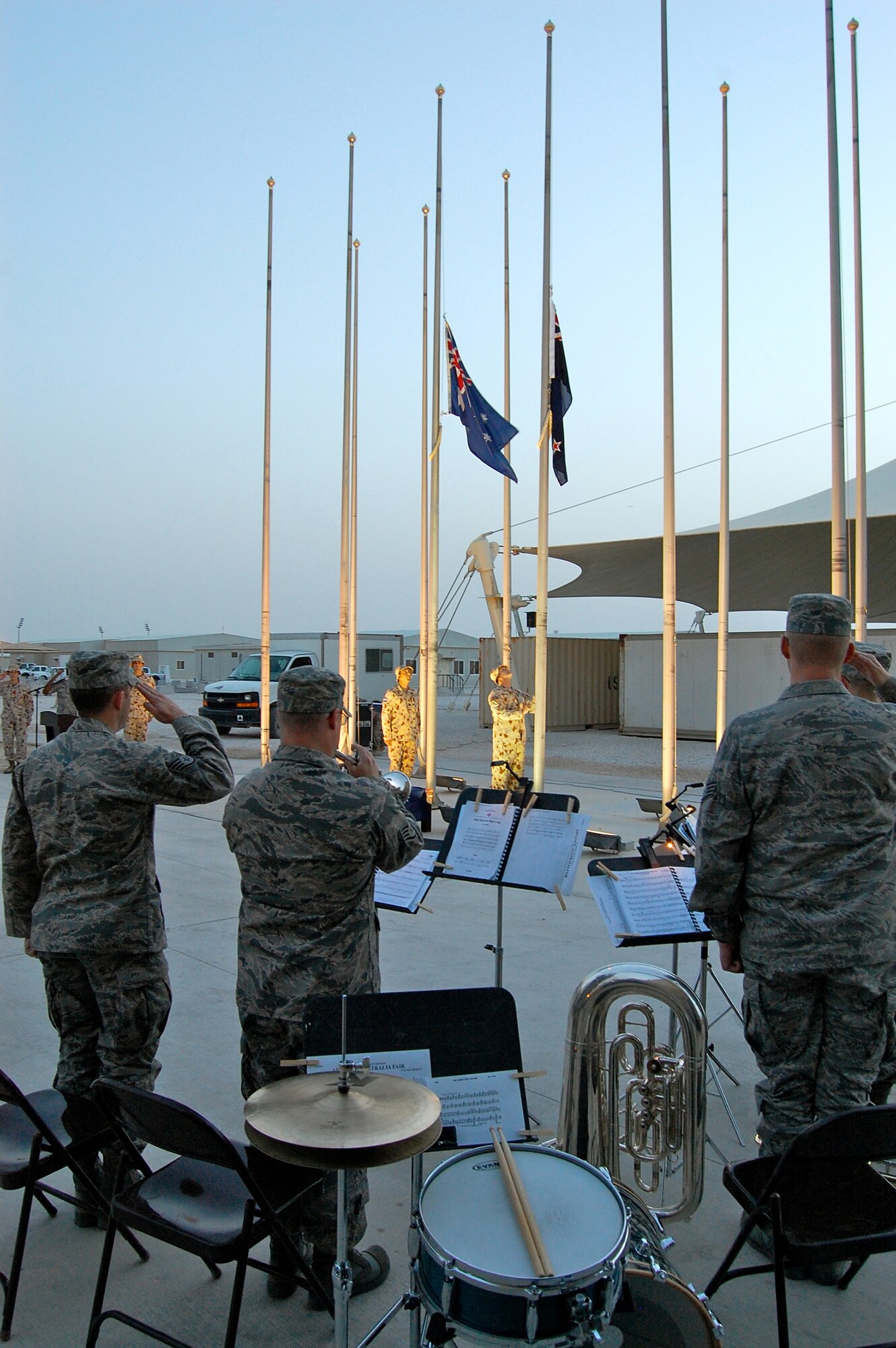Staff Sgt. Mark Nixon, U.S. Air Forces Central Command Band, sounds "Last Call" after the Australian and New Zealand Flags are lowerd to half mast April 25, 2010, in recognition of Australian and New Zealand Army Corps Day here. (U.S. Air Force photo/Maj. Chad Steffey/released)