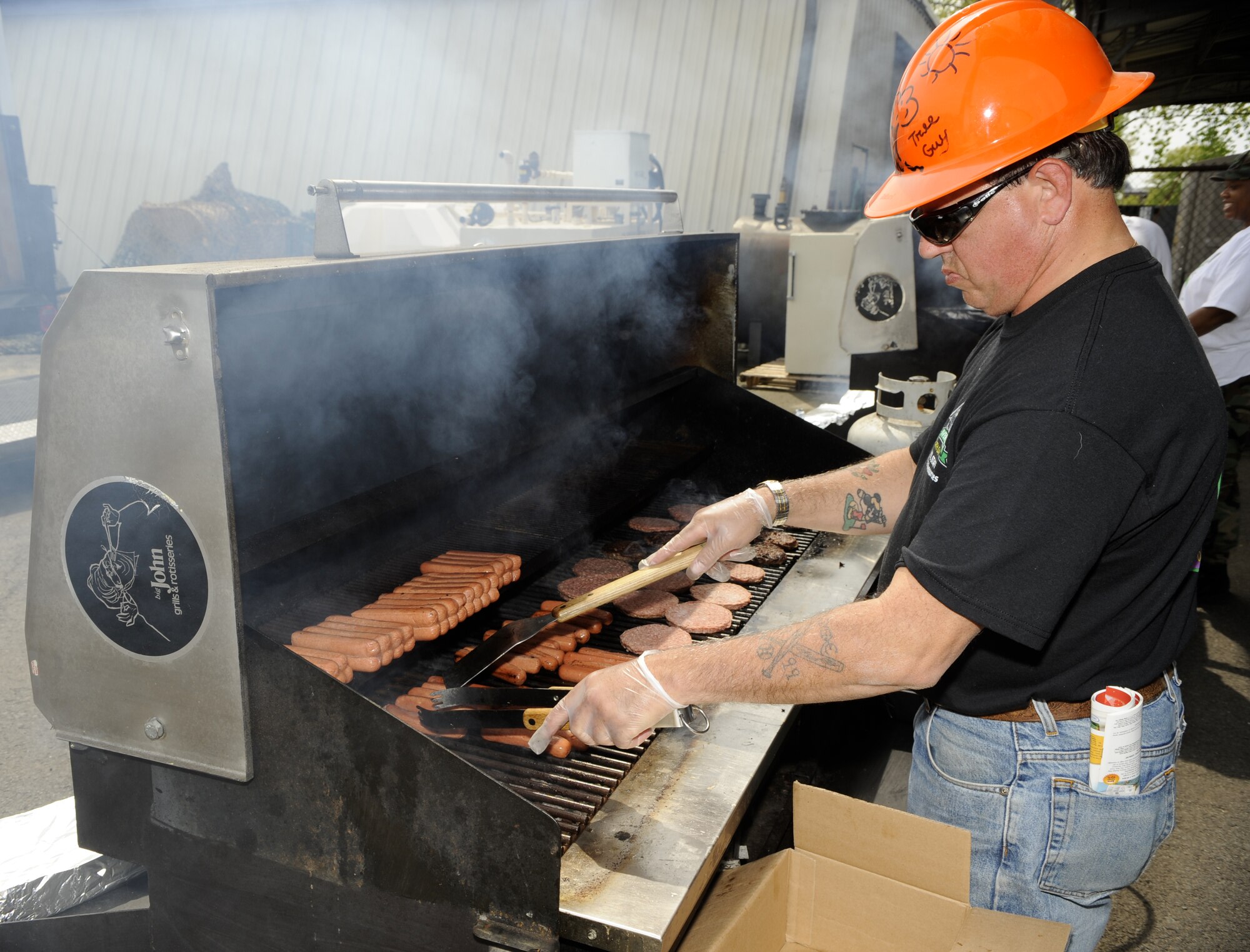 Chuck Beam, 108th Wing, Air National Guard Environmental Coordinator, volunteered to operate the grill at the Earth Day event April 21 on Joint Base McGuire-Dix-Lakehurst.  Guests were served grilled hot dogs, hamburgers, chips and cookies. (U.S. Air Force photo/Carlos Cintron)