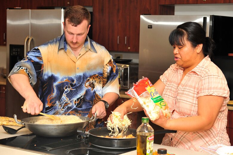 BUCKLEY AIR FORCE BASE, Colo.-- Paul Kelly assists his wife, Filomena, with her cooking class April 23 at the HAWC. Filomena was taught to cook traditional Filipino food by her mother. (U.S. Air Force Photo by Airman 1st Class Manisha Vasquez)