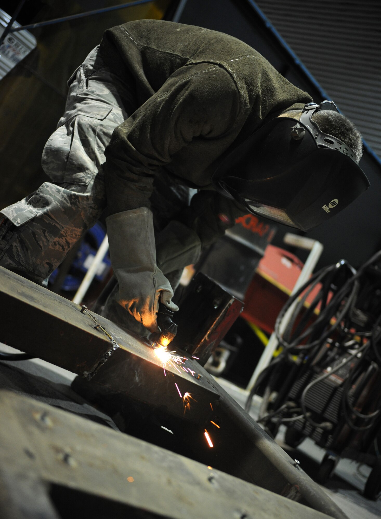 RAF MILDENHALL, England – Senior Airman Joseph Easley, 100th Logistics Readiness Squadron vehicle maintenance technician, uses a plasma cutter to slice through the frame section from a fire truck during training at the vehicle maintenance flight April 21. Airman Easley trains to become certified and efficient with tools used in the auto-body shop. (U.S. Air Force photo/ Staff Sgt. Jerry Fleshman)