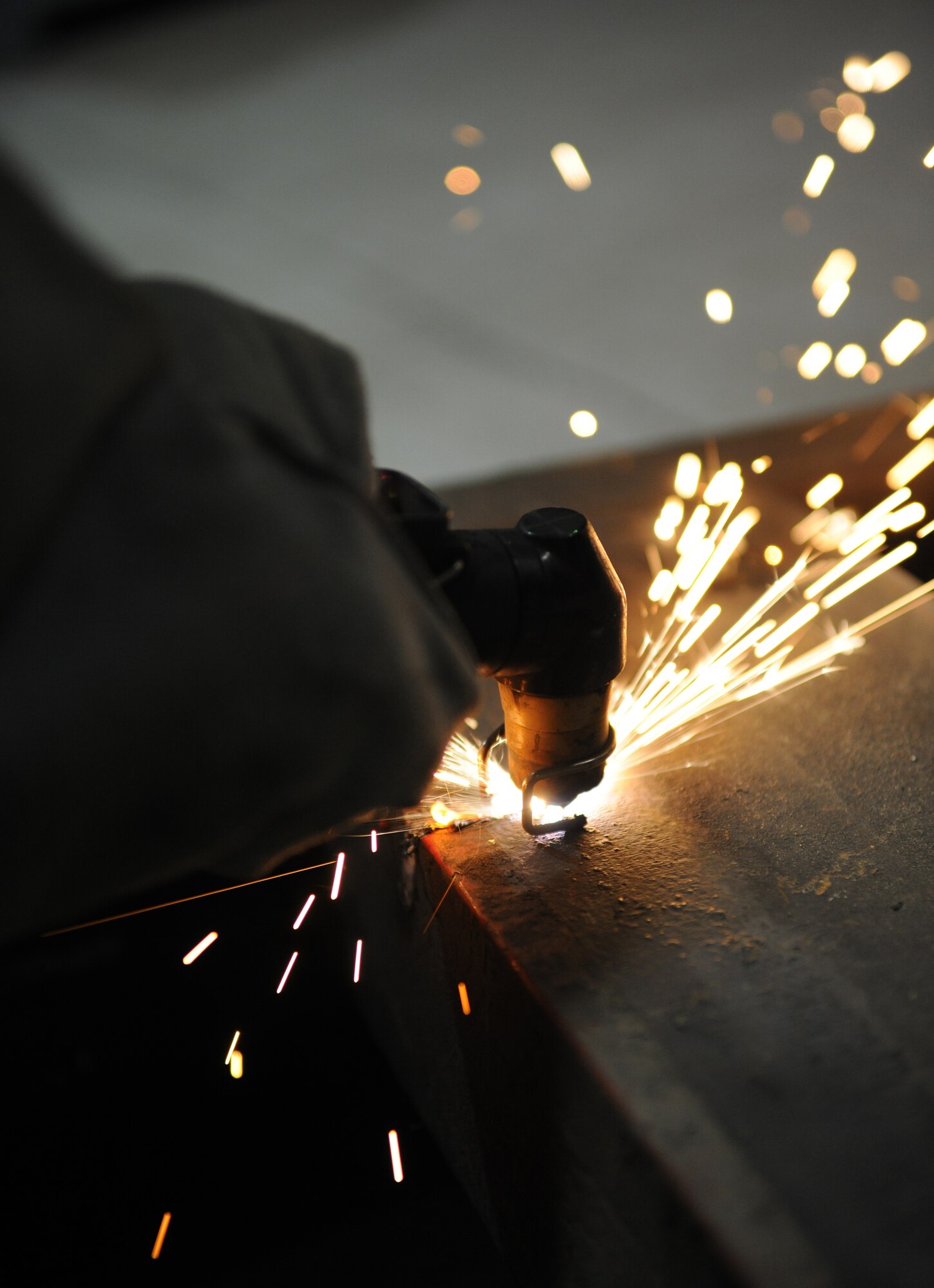RAF MILDENHALL, England – Senior Airman Joseph Easley, 100th Logistics Readiness Squadron vehicle maintenance technician, uses a plasma cutter to split through the frame from a fire truck during training at the vehicle maintenance flight April 21. (U.S. Air Force photo/ Staff Sgt. Jerry Fleshman)
