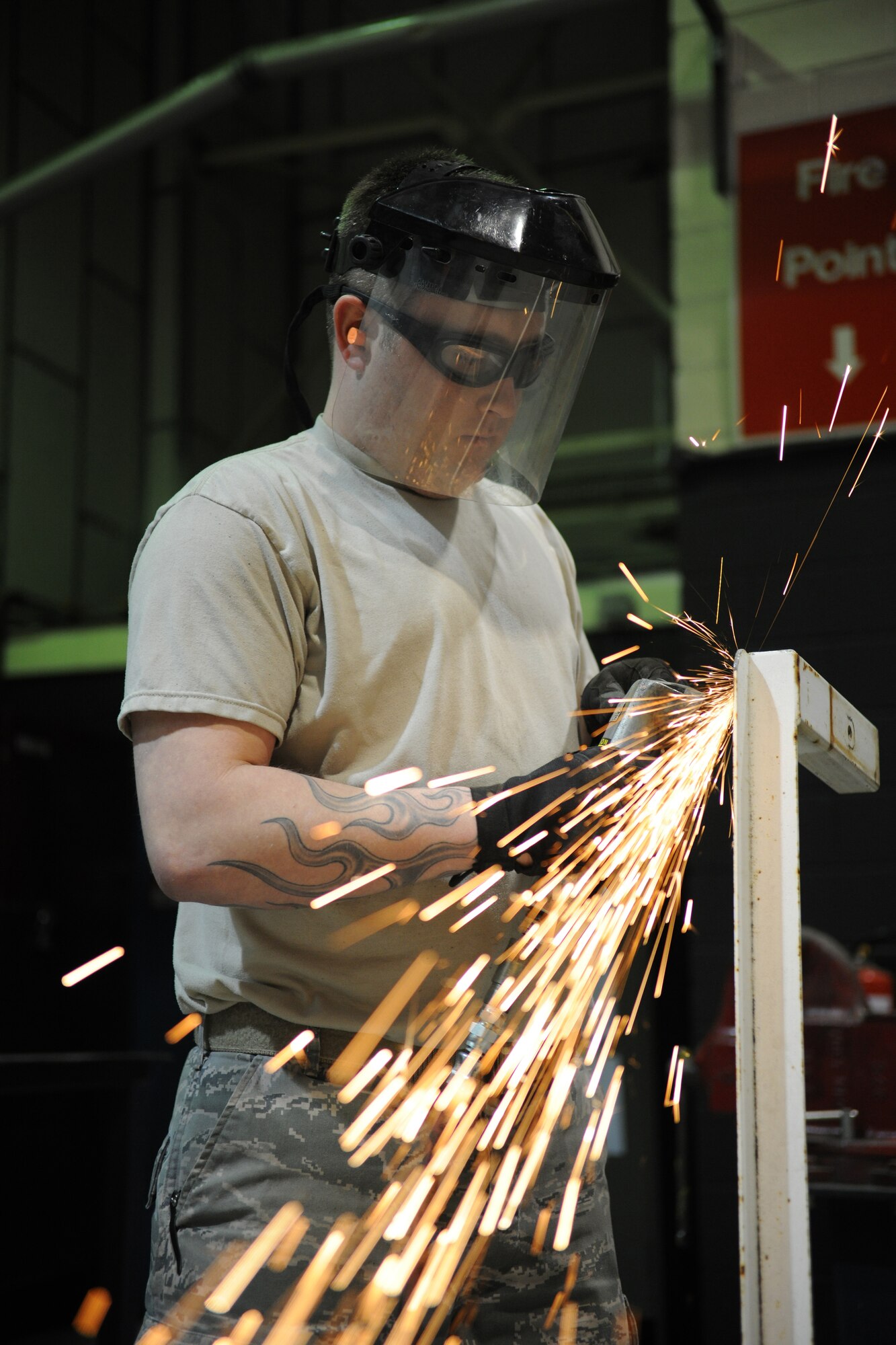 RAF MILDENHALL, England – Senior Airman Joseph Easley, 100th Logistics Readiness Squadron vehicle maintenance technician, uses a grinder to remove welds from an old light bar to be turned into scrap metal April 21. (U.S. Air Force photo/ Staff Sgt. Jerry Fleshman)