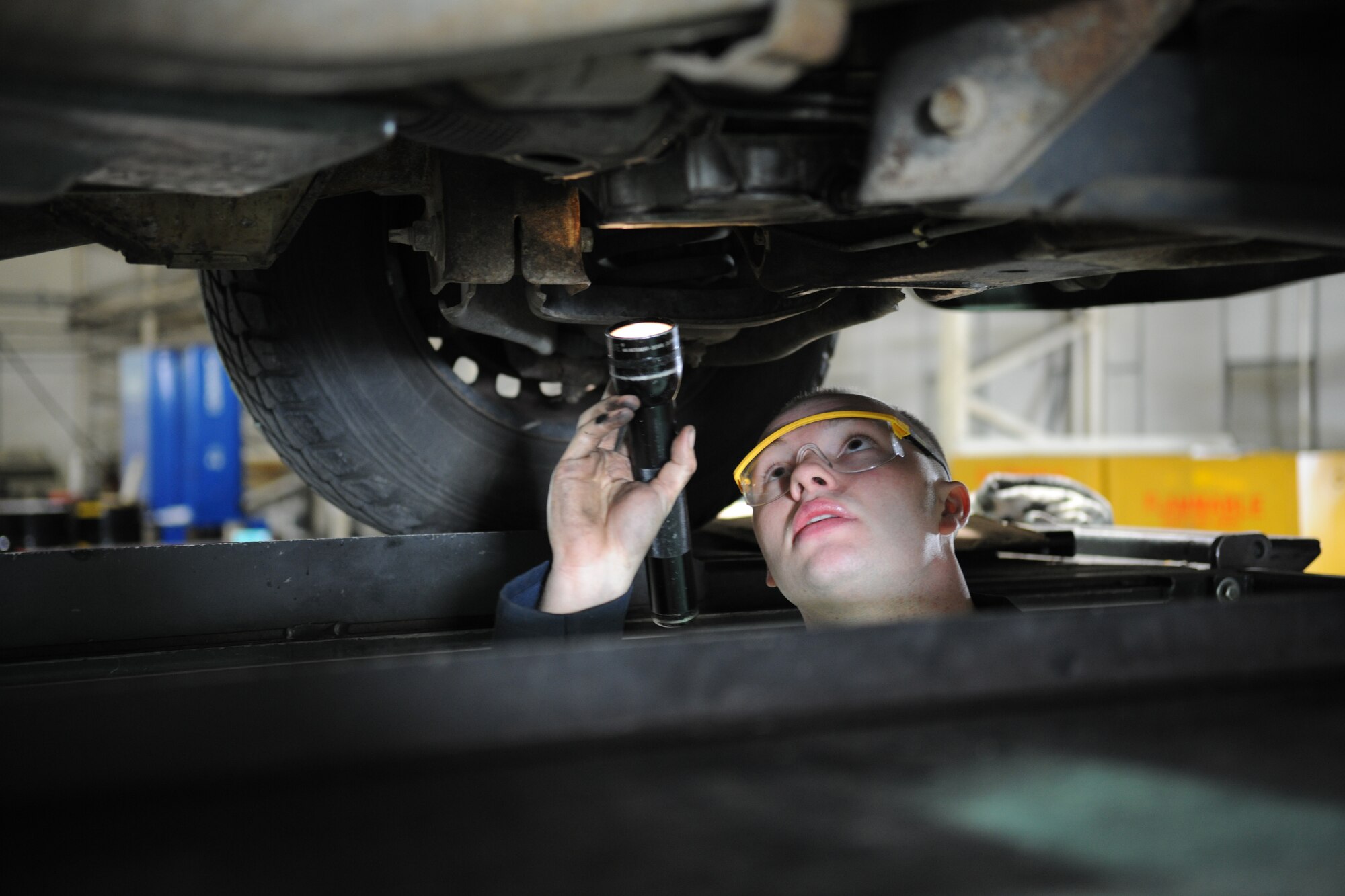 RAF MILDENHALL, England – Airman 1st Class Justin Hedlund, 100th Logistics Readiness Squadron vehicle maintenance technician, searches the underbody of a truck for an oil leak found during a routine inspection April 21. The maintenance shop performs these inspections to ensure government vehicles are properly serviced and are within safe drivable limits. (U.S. Air Force photo/ Staff Sgt. Jerry Fleshman)