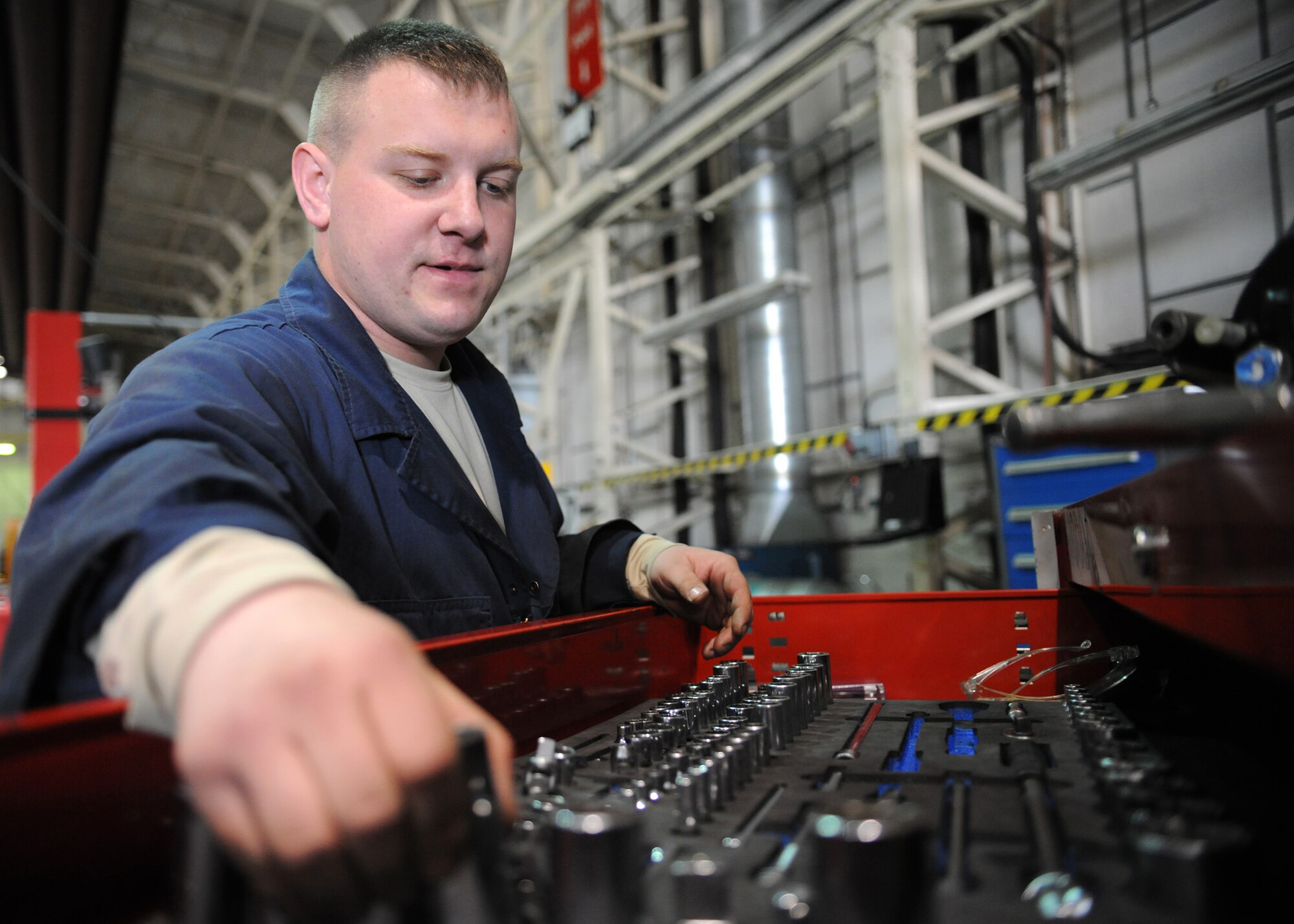 RAF MILDENHALL, England – Senior Airman Sean Dennison, 100th Logistics Readiness Squadron vehicle maintenance technician, reaches for a socket during a power steering pump installation April 23. (U.S. Air Force photo/ Staff Sgt. Jerry Fleshman)
