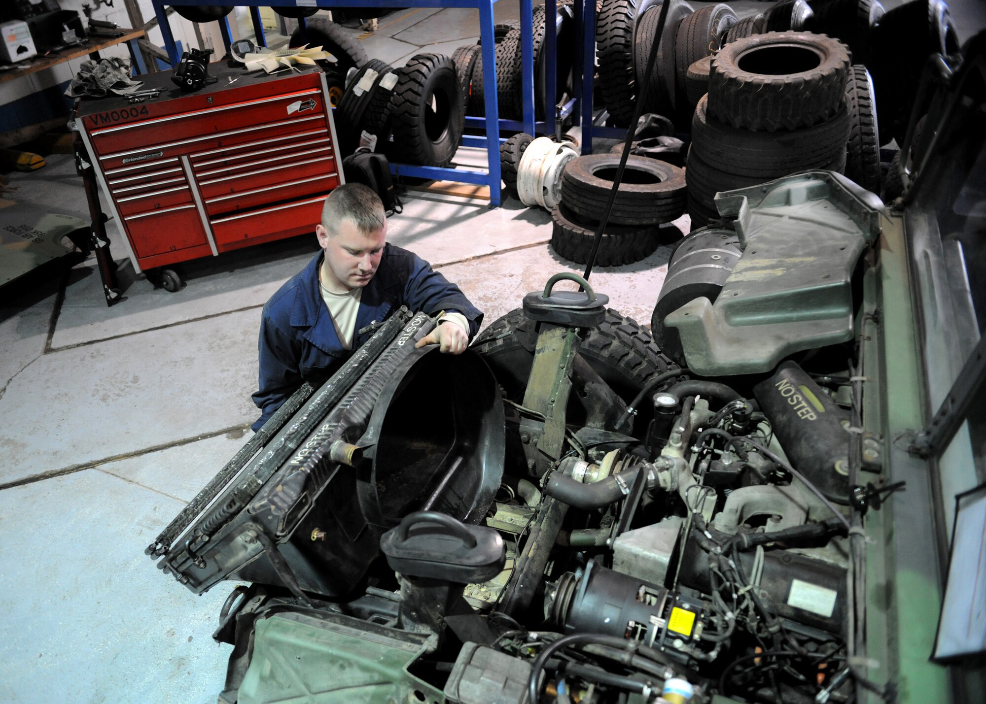 RAF MILDENHALL, England – Senior Airman Sean Dennison, 100th Logistics Readiness Squadron vehicle maintenance technician, installs a radiator onto a high mobility multipurpose wheeled vehicle (HMMWV) during a power steering replacement April 23. (U.S. Air Force photo/ Staff Sgt. Jerry Fleshman)