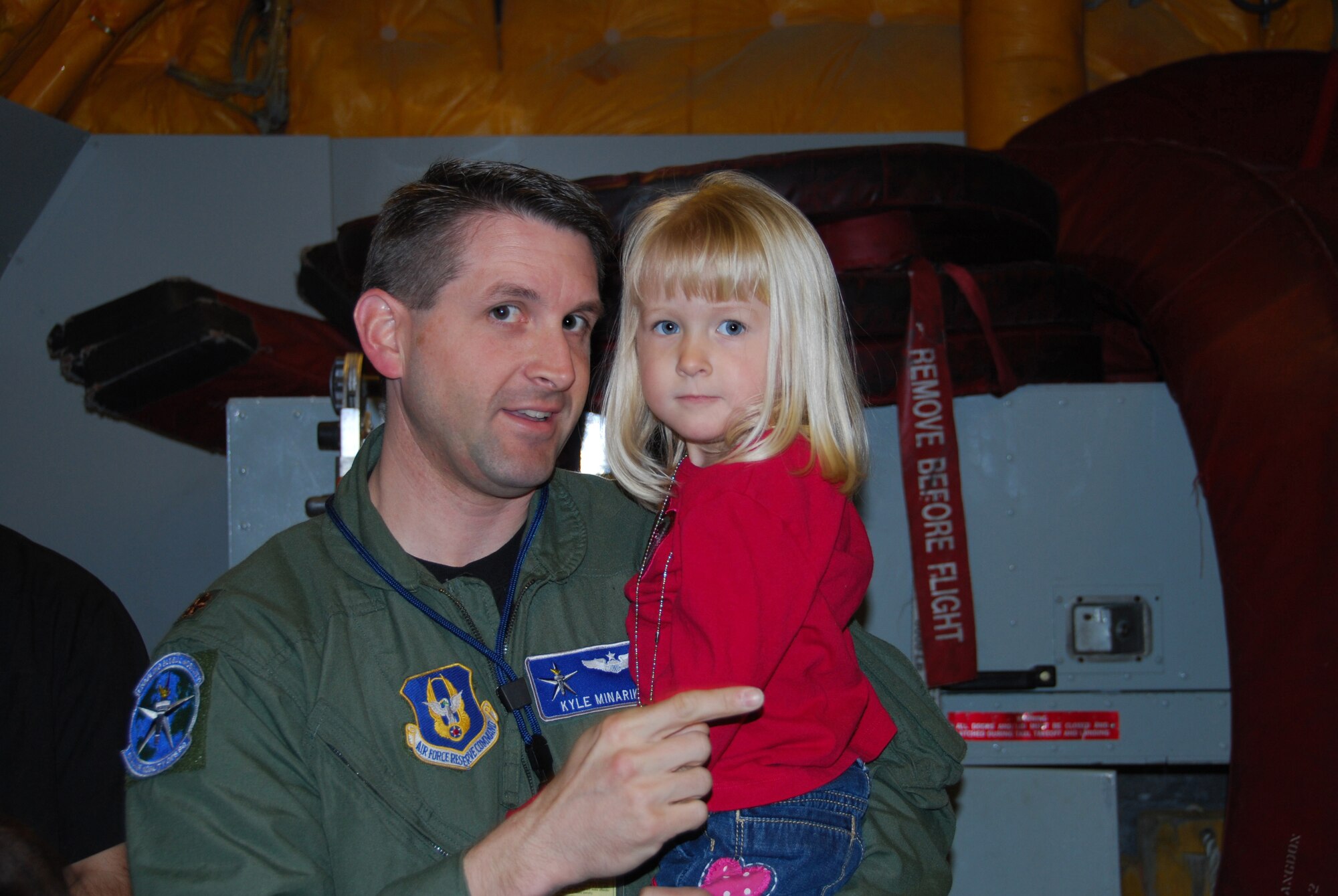JOINT BASE MCGUIRE-DIX-LAKEHURST, N.J. - Maj. Kyle Minarik a Reserve pilot here, shares some time with his daughter at the KC-10 Extender static display; one of several sites more than 60 members visited April 22 during National Bring Your Child to Work Day. (U.S. Air Force photo/Master Sgt. Donna T. Jeffries)