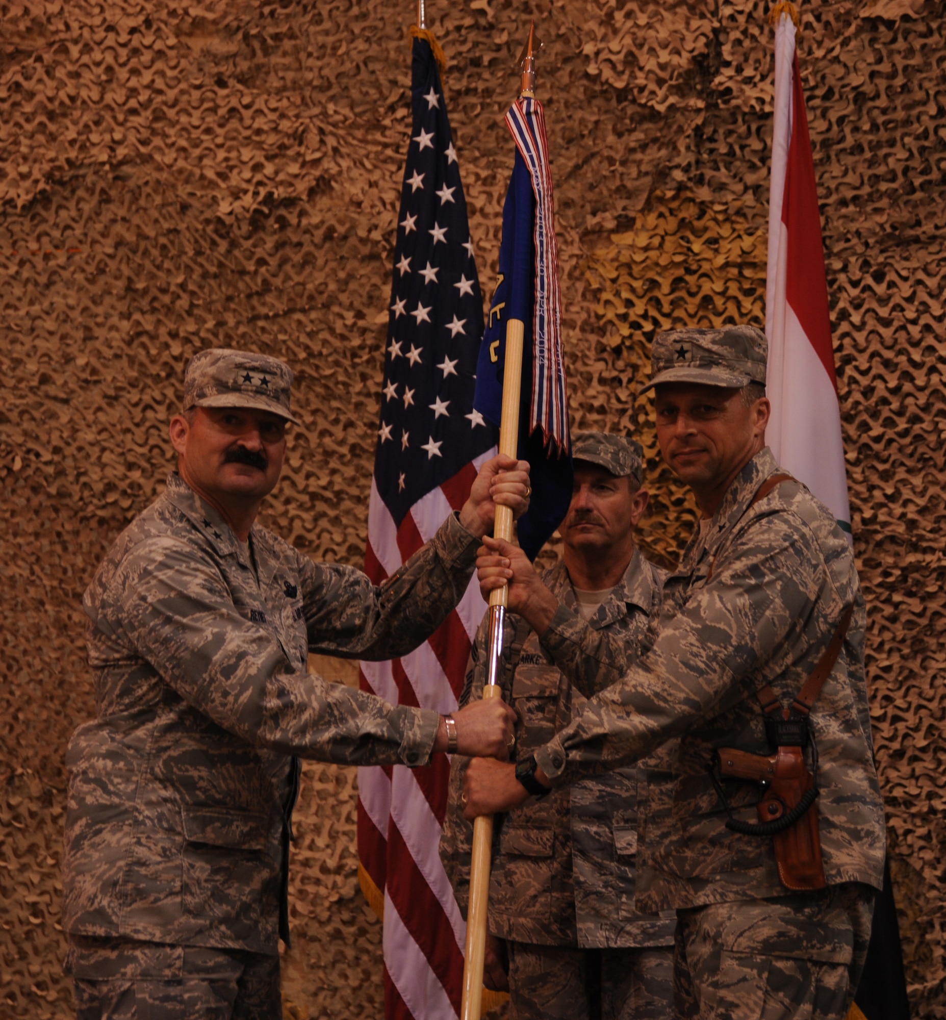 Maj. Gen. Joseph Reynes Jr., director, Air Component Coordination Element U.S. Forces- Iraq, hands the 447th Air Expeditionary Group flag to Brig. Gen. Scott Hanson, 321st Air Expeditionary Wing commander, during the 447th AEG tranfer of authority ceremony held April 24, 2010. During the ceremony the 447 AEG was transfered from the 332nd Air Expeditionary Wing to the 321st AEW. (U.S. Air Force photo/ Senior Airman Eric Summers Jr./ released) 