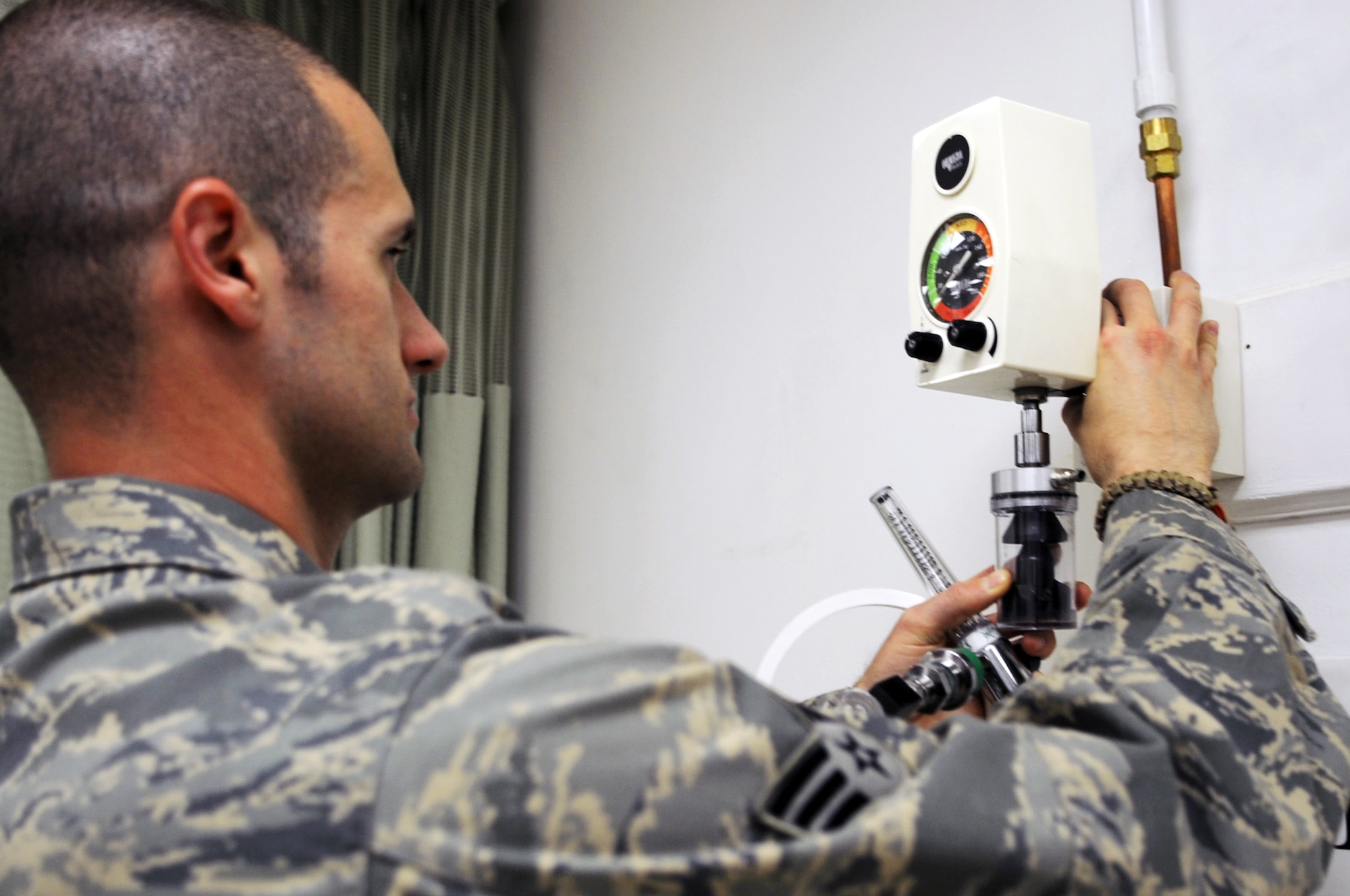 Senior Airman Michael Neal, 332nd Medical Support Squadron biomedical maintenance technician, removes equipment from hospital walls during the construction phase of the Contingency Aeromedical Staging Facility and the Air Force Theater Hospital merger at Joint Base Balad, April 13, 2010. The intensive care unit and intermediate care ward are now combined. The Air Force public health and bioenvironmental offices will be brought onto the medical campus as well. All the moves will help increase the overall capabilities of the AFTH, while decreasing the American footprint in preparation toward turnover of the base to the Iraqi military in December 2011. (U.S. Air Force photo/Senior Airman Brittany Y. Bateman/Released)