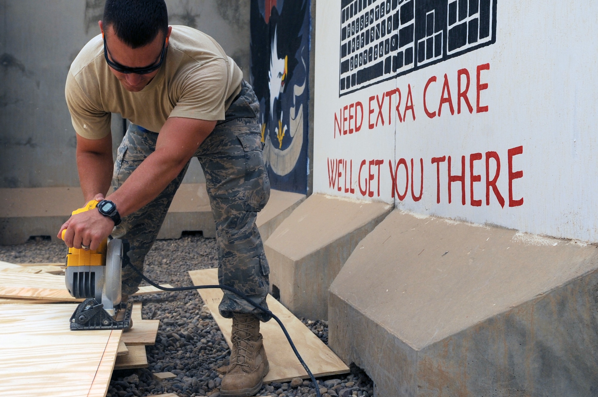 Staff Sgt. Shaun Lyle, 332nd Expeditionary Civil Engineer Squadron structural craftsman, uses a hand saw to cut wood during the construction phase of the Contingency Aeromedical Staging Facility and Air Force Theater Hospital merger at Joint Base Balad, April 13, 2010. The Air Force public health and bioenvironmental offices will also be brought onto the medical campus, along with the newly combined intensive care unit and intermediate care ward. All the moves will help increase the overall capabilities of the AFTH, while decreasing the American footprint in preparation toward turnover of the base to the Iraqi military in December 2011. (U.S. Air Force photo/Senior Airman Brittany Y. Bateman/Released)