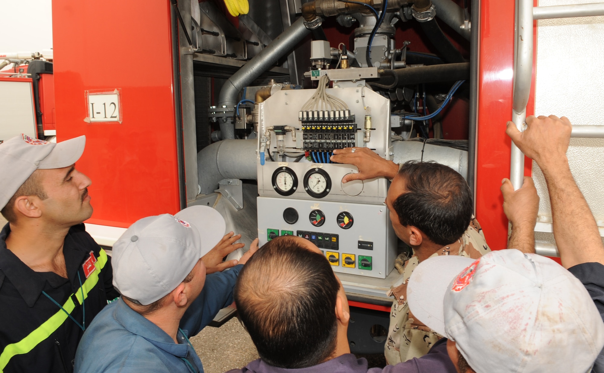Members from the 506th Air Expeditionary Group and Iraq Training and Advisory Mission facilitated a maintenance education day between the Province of Kirkuk Fire Department (PKFD) and the Iraq Air Force Fire Department (IqAF/FD) at Kirkuk Regional Air Base, Iraq.  The PKFD members shared their knowledge of how to repair the European-type fire equipment with the IqAF vehicle maintainers.  (U.S. Air Force photo/Staff Sgt. Tabitha Kuykendall/Released)