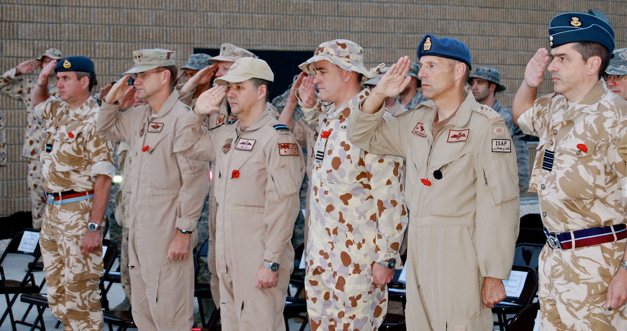 Senior officers from the air components of the United Kingdom, the United States, Australia, Canada and France present arms during the Australian National Anthem. Each wore a red poppy, the traditional symbol of remembrance for ANZAC Day. (U.S. Air Force photo/Maj. Chad Steffey/released)