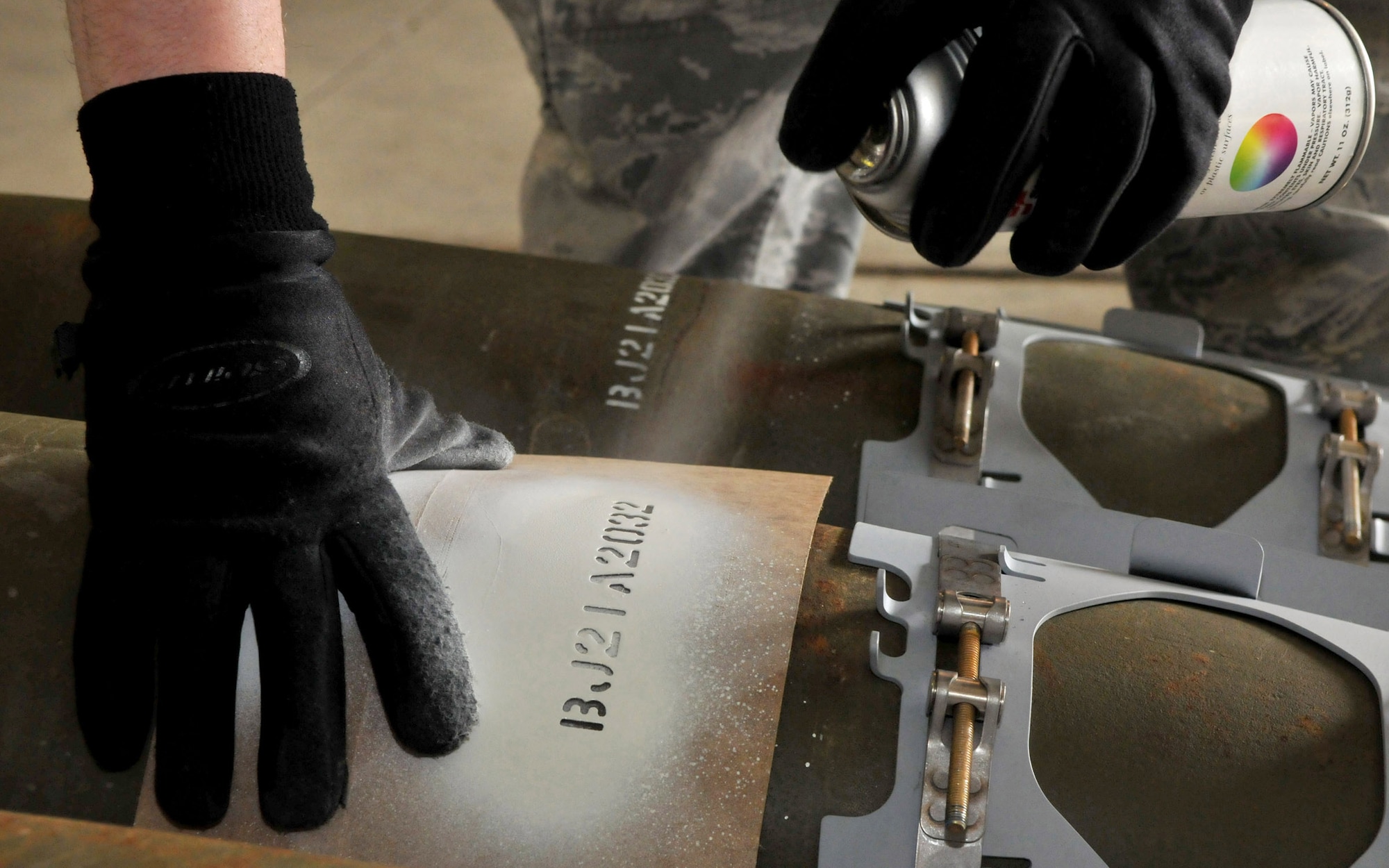A conventional maintenance crew member with the 8th Maintenance Squadron, Kunsan Air Base, Republic of Korea, stencils a weapon stock number onto a Joint Direct Attack Munition GBU-38 during Red Flag-Alaska at Eielson Air Force Base, Alaska, April 16. The numbers help the Airmen track all of the different pieces of the bomb for accountability. (U.S. Air Force photo/Capt. Shannon Collins)