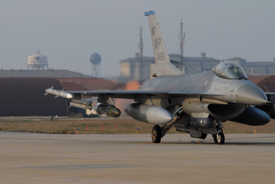 KUNSAN AIR BASE, Republic of Korea -- An F-16 Fighting Falcon taxis down the runway with live ammuniton here April 23. Wolf Pack participated in a no notice exercise testing the wing's ability to quickly and efficiently load live weapons and execute the operational mission. (U.S. Air Force photo/Staff Sgt. Darnell T. Cannady)