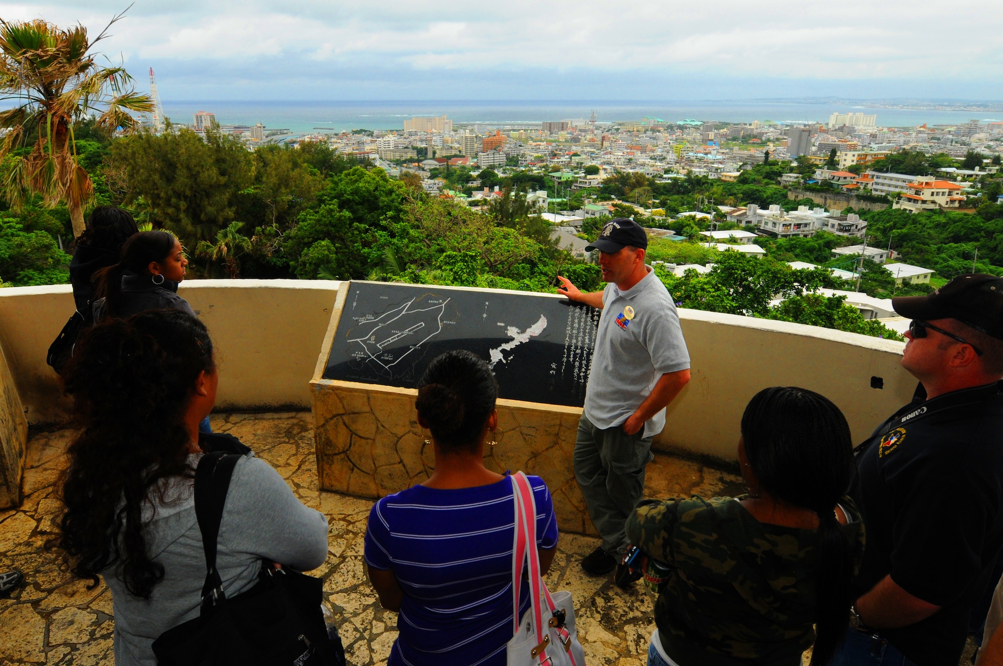 Chris Majewski, a Marine Corps Community Service tour guide, describes the American invasion of Okinawa from the summit of Kakazu Ridge. Atop Kakazu Ridge stands a two story observation tower that offers a 360 degree view of the island including many battle sites. (U.S. Air Force photo/Staff Sgt. Christopher Hummel)