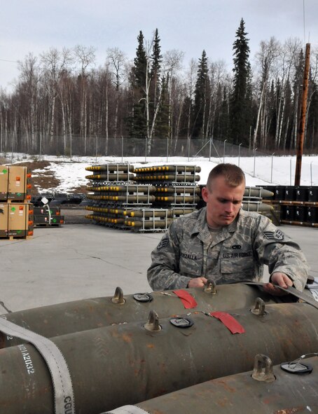 Staff Sgt. Eric Worzalla, munitions controller, secures a Joint Direct Attack Munition GBU-38 onto a munitions trailer during Red Flag-Alaska at Eielson Air Force Base, Alaska, April 16. Sergeant Worzalla is deployed from the 4th Equipment Maintenance Squadron, Seymour Johnson Air Force Base, N.C. (U.S. Air Force photo/Capt. Shannon Collins)