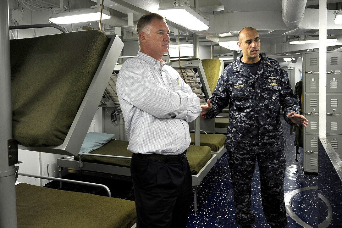 Deputy Defense Secretary William J. Lynn III talks with Navy Cmdr. (Dr.) Alfred Shwayhat aboard the USS Carl Vinson on Naval Air Station North Island, Calif., April 26, 2010.