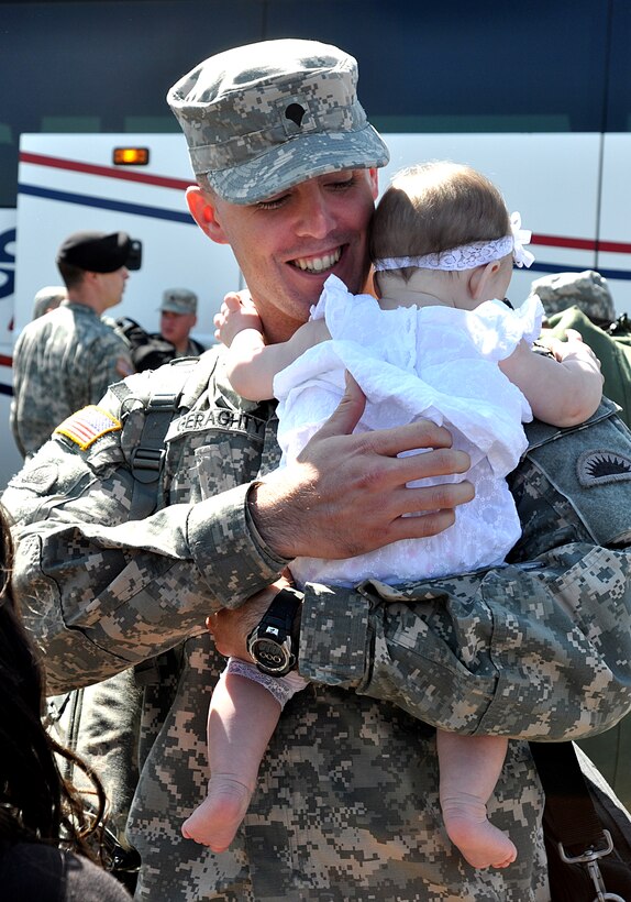 U.S. Army Spc. Nicholas Geraghty holds his daughter, Aubrey, at the Lane County Fairgrounds before the demobilization ceremony in Eugene, Ore., April 23, 2010. Geraghty is assigned to the 2nd Battalion, 162nd Infantry Regiment, 41st Infantry Brigade Combat Team, Oregon Army National Guard, and returned home after a 400-day deployment to support Operation Iraqi Freedom. 