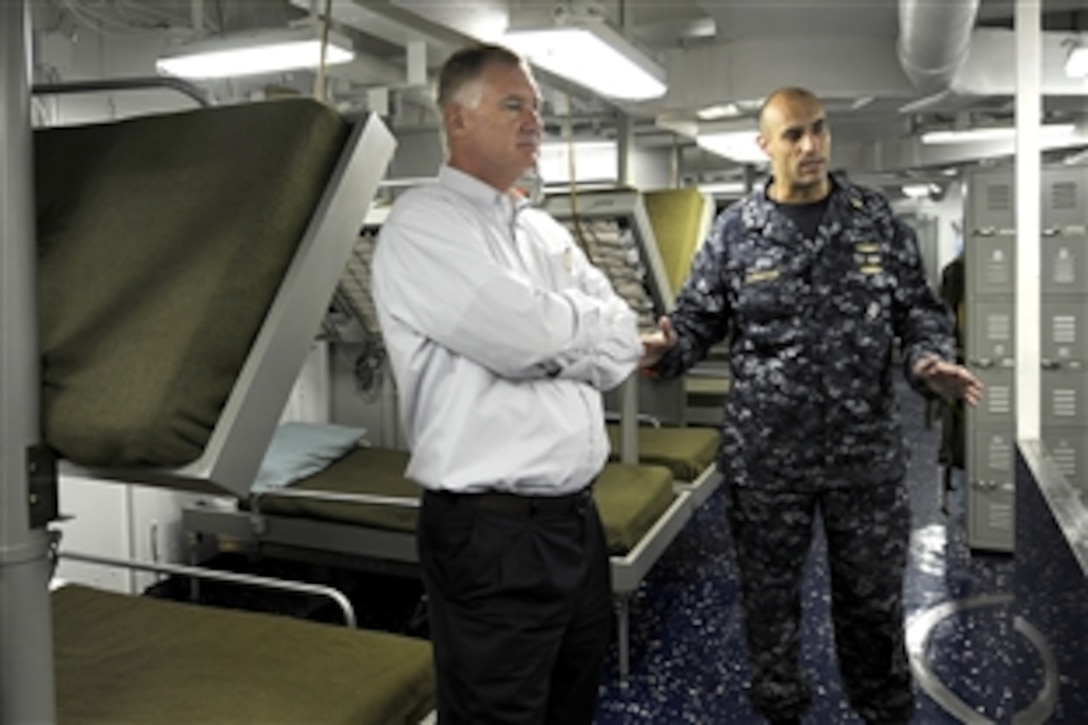 Deputy Defense Secretary William J. Lynn III talks with Navy Cmd. (Dr.) Alfred Shwayhat on board the USS Carl Vinson in port at Naval Air Station North Island, Calif., April 26, 2010.