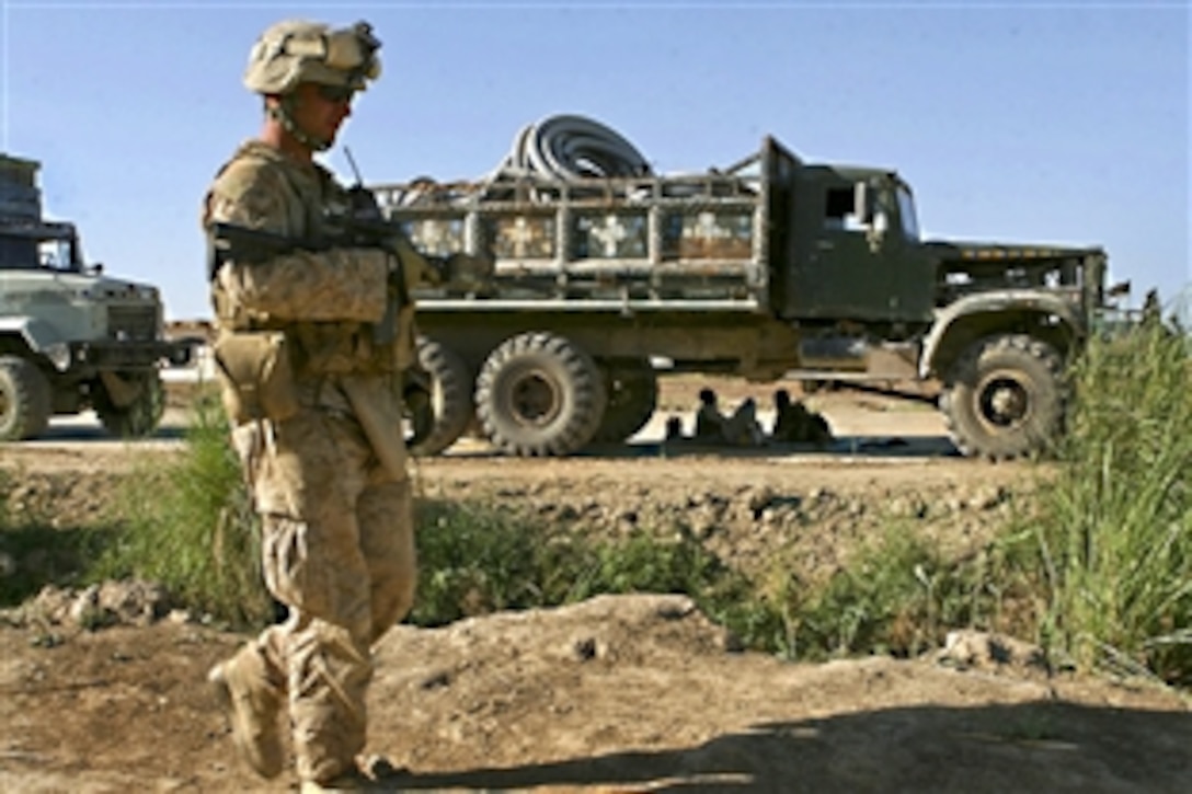 A U.S. Marine sets out on patrol with Afghan forces in Marja, Afghanistan, April 23, 2010, where they met with farmers and landowners participating in the Marja Accelerated Agricultural Transition program. The Marine is assigned to the Weapons Company, 1st Battalion, 6th Marine Regiment.