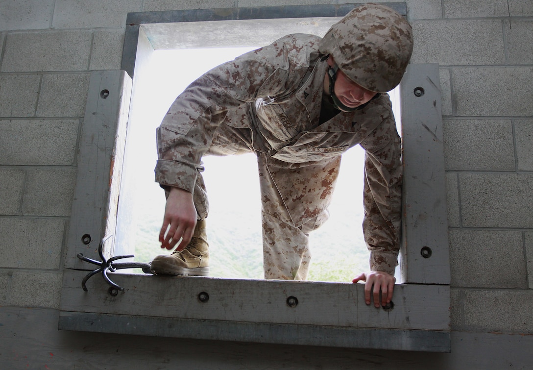 Lance Cpl. Dustin T. Weese, personnel clerk, Headquarters & Support Battalion, Marine Corps Base Camp Pendleton, climbs through a second story window, using a grappling hook, during Military Operations on Urban Terrain training at Camp Pendleton, April 27. Although HQSPT Bn., MCB Camp Pendleton is a non-deployable unit, the organization conducted the pre-deployment exercises, April 26-30, to keep its Marines’ skills sharp.