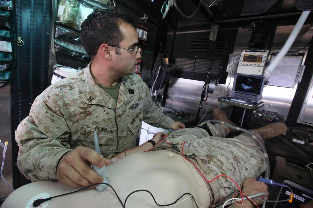 Petty Officer 2nd Class Michael J. Pena, 26, from Munford, Tenn., aviation physiology technician with Alpha Surgical Company, 1st Medical Battalion, 1st Marine Logistics Group (Forward), performs an internal scan to make sure a simulated patient’s heart is functioning normally inside a Mobile Trauma Bay at Camp Dwyer, Afghanistan, April 27. An MTB is an armored container on top of a Logistics Vehicle System Replacement, consisting of one doctor, one nurse and three corpsmen, that brings medical treatment closer to the battlefield.