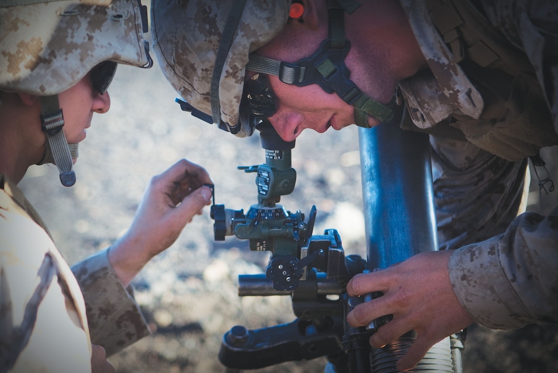 Pfc. Ethan P. Usborne and Pfc. Derek D. Foley adjust an 81 mm mortar tube to ensure maximum accuracy on April 27 while training at the Pohakuloa Training Area. These Marines have recently been joined by trained riflemen who now are being cross-trained to the mortar men MOS.