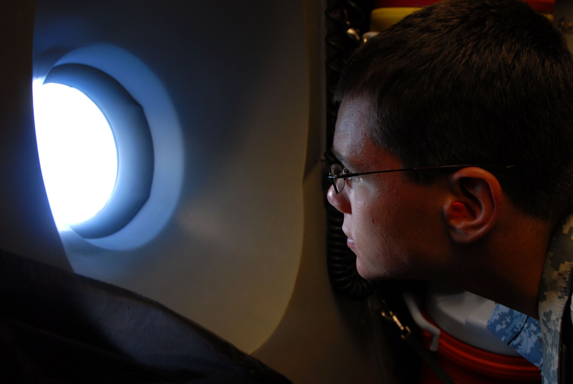JOINT BASE PEARL HARBOR HICKAM, Hawaii - Kenny Grant, Air Force Reserves Officers' Training Corps cadet from the University of Hawaii Detachment 175th, looks out the window of a C-17 Globemaster III during an incentive flight here, April 28. The annual incentive flight exposes cadets to active duty positions and allows them to get a first hand look at the pilot programs and other types of air force specialty codes. (U.S. Air Force photo/Senior Airman Gustavo Gonzalez)