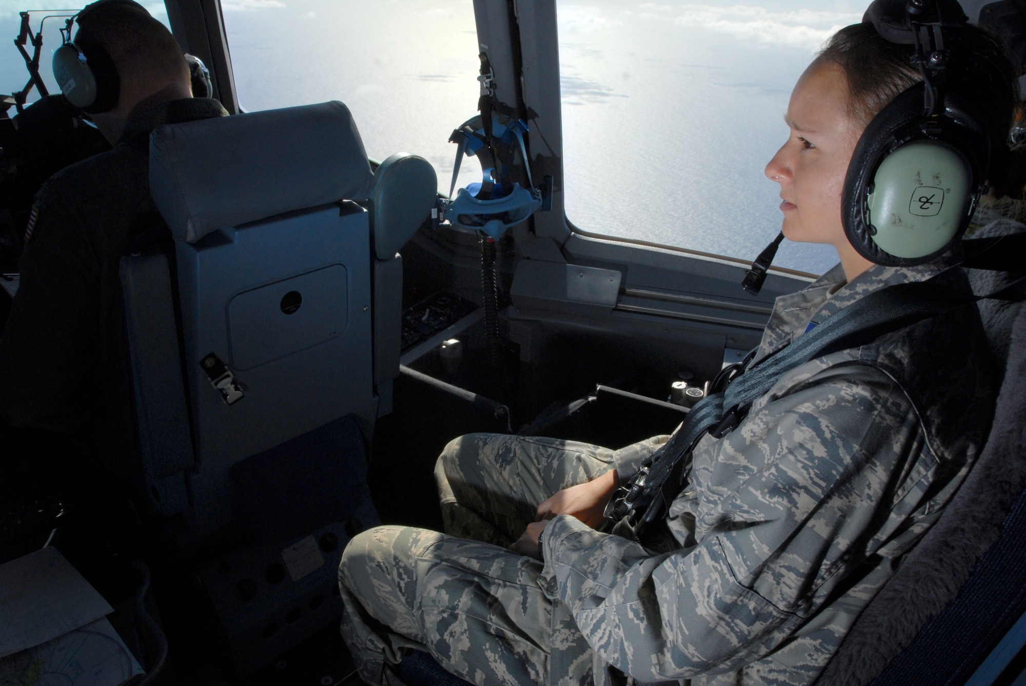 JOINT BASE PEARL HARBOR HICKAM, Hawaii - Gabriel Esakew, Air Force Reserves Officers' Training Corps cadet from the University of Hawaii Detachment 175th, observes pilots on the cockpit of a C-17 Globemaster III during an incentive flight here, April 28. The annual incentive flight exposes cadets to active duty positions and allows them to get a first hand look at the pilot programs and other types of air force specialty codes. (U.S. Air Force photo/Senior Airman Gustavo Gonzalez)