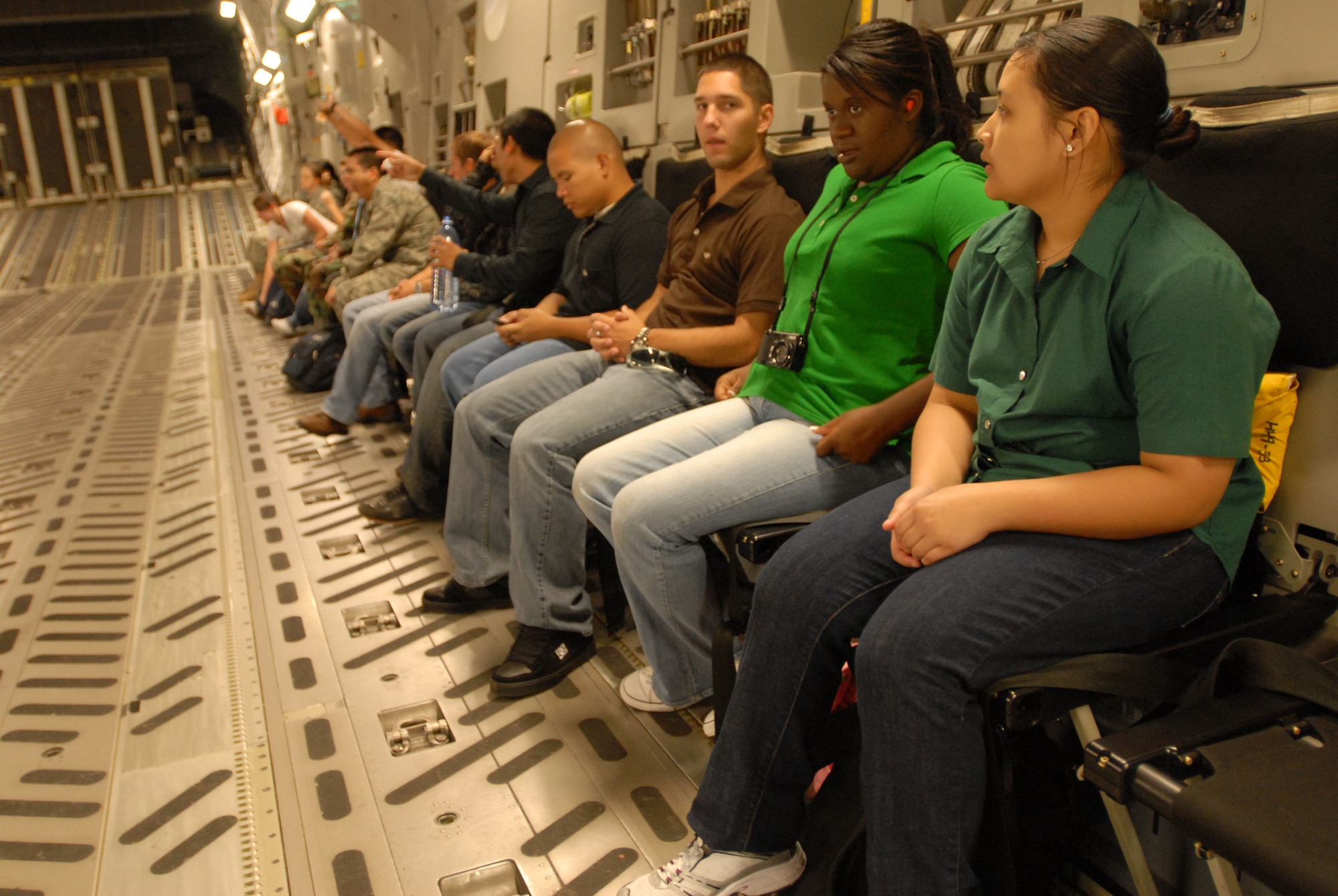 JOINT BASE PEARL HARBOR HICKAM, Hawaii - Army Reserves Officers' Training Corps and Air Force Reserves Officers' Training Corps cadets from the University of Hawaii Detachment 175th, are seated and fasten their seat belts before taking off on a C-17 Globemaster III during an incentive flight here, April 28. The annual incentive flight exposes cadets to active duty positions and allows them to get a first hand look at the pilot programs and other types of air force specialty codes. (U.S. Air Force photo/Senior Airman Gustavo Gonzalez)