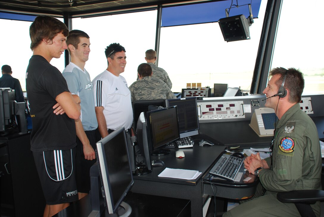 Midwestern State University Soccer Team members Chad Caldwell (front), Kelly Gill (center) and Rob Cummings (back) get a control tower overview from Major Mike Lange (right), 80th Flying Training Wing supervisor of flying, April 28, 2010.  The MSU team provides an annual youth soccer clinic for Sheppard children . (U.S. Air Force photo/Debi Smith)