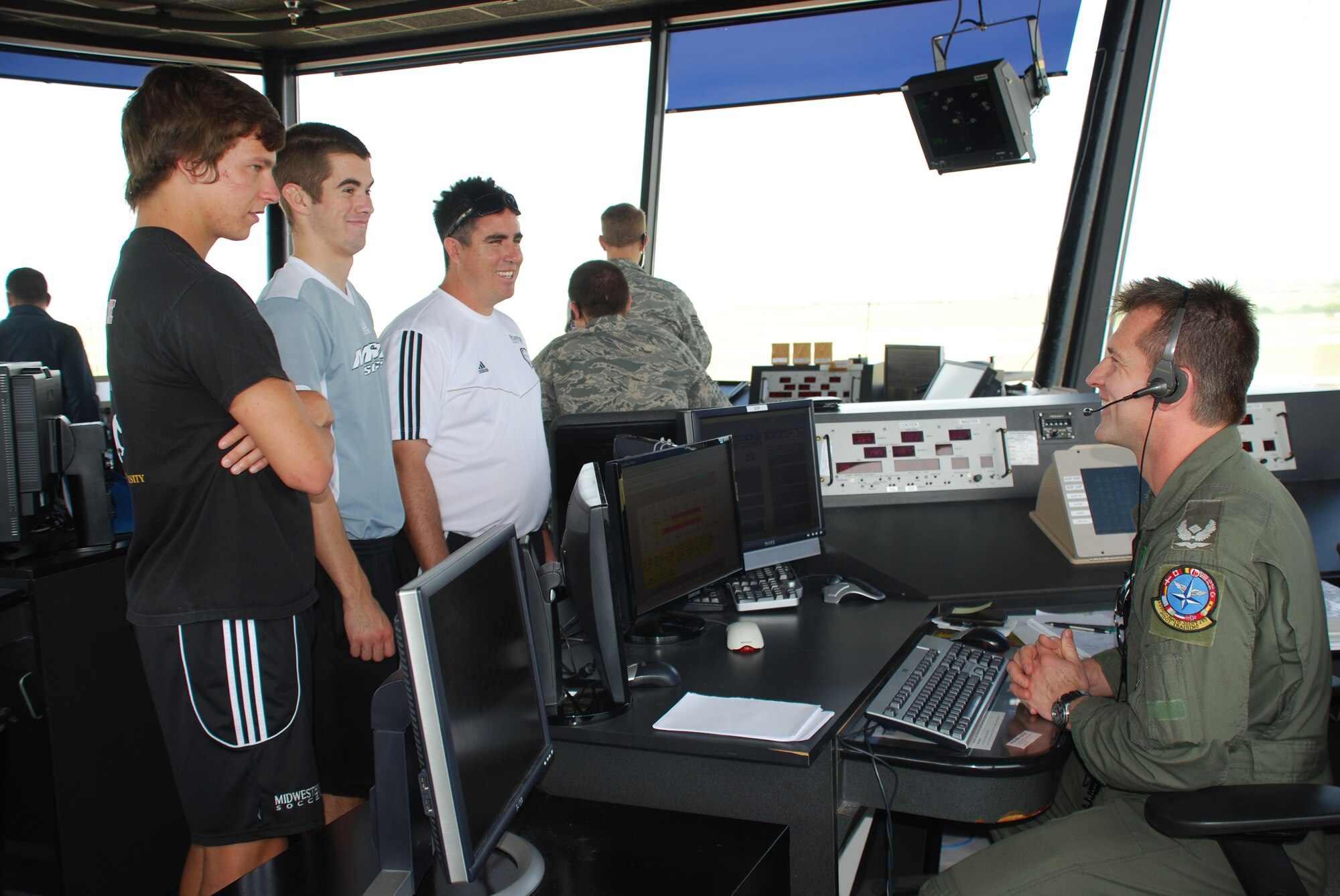 Midwestern State University Soccer Team members Chad Caldwell (front), Kelly Gill (center) and Rob Cummings (back) get a control tower overview from Major Mike Lange (right), 80th Flying Training Wing supervisor of flying, April 28, 2010.  The MSU team provides an annual youth soccer clinic for Sheppard children . (U.S. Air Force photo/Debi Smith)