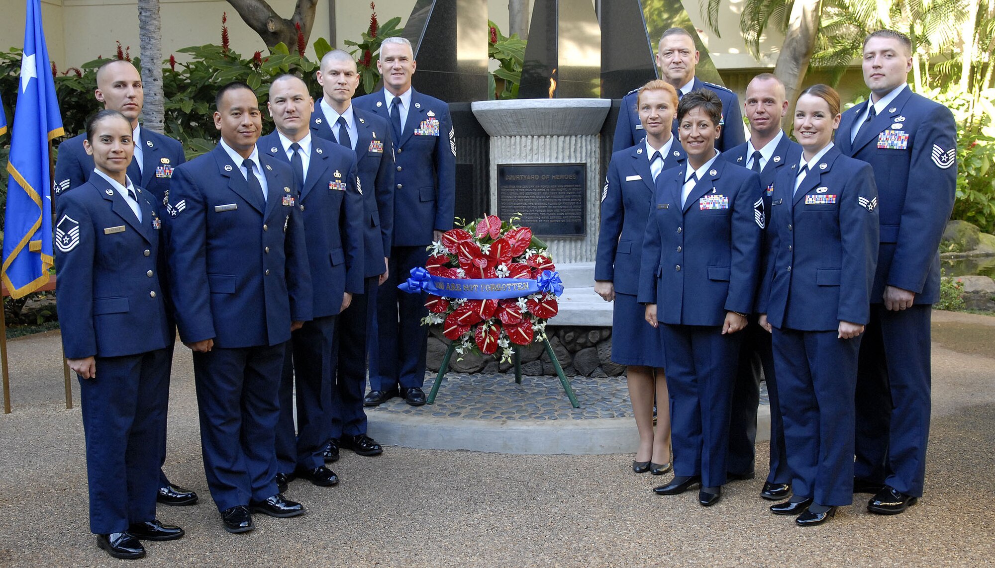 Gen. Gary North, Pacific Air Forces commander, PACAF, Command Chief Master Sergeant Brooke McLean, and PACAF?s outstanding Airmen of the year pose for a group photo after a wreath laying ceremony at the Courtyard of Heroes, Headquarters Pacific Air Forces, Joint Base Pearl Harbor Hickam, Hawaii, April 26, 2010.  The group presided over the ceremony honoring those who died at Hickam Air Field, Dec. 7, 1941.  (U.S.  Air Force photo/Tech. Sgt. Jerome S. Tayborn)