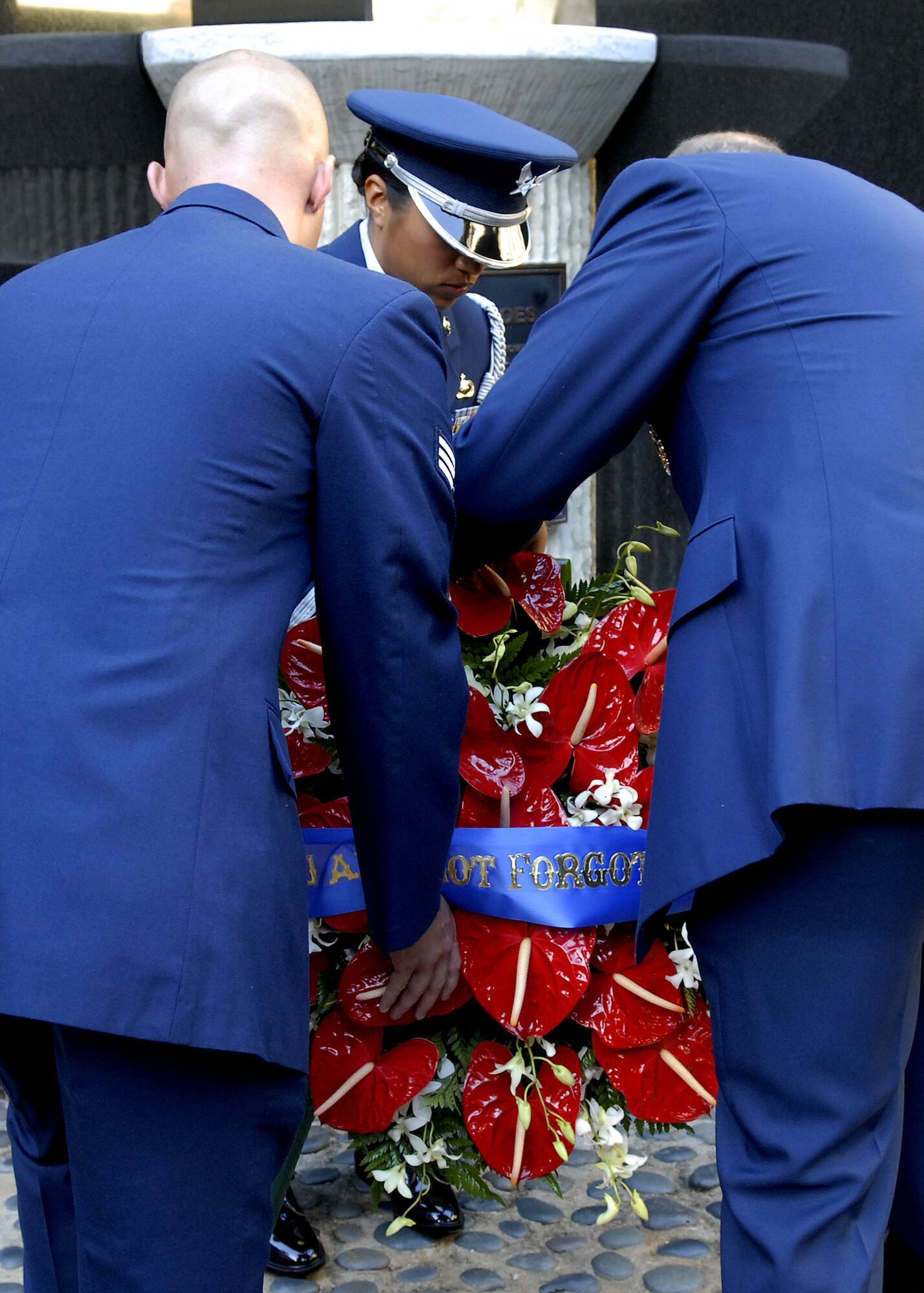 Gen. Gary North, Pacific Air Forces commander, and Senior Airman David K.P. Rivera, one of Pacific Air Forces Airmen of the year, lay a wreath at the Courtyard of Heroes, Headquarters Pacific Air Forces, Joint Base Pearl Harbor Hickam, Hawaii, April 26, 2010. General North, Pacific Air Forces, Command Chief Master Sergeant Brooke McLean and PACAF?s outstanding Airmen presided over the ceremony honoring those who died at Hickam Air Field, Dec. 7, 1941. (U.S.  Air Force photo/Tech. Sgt. Jerome S. Tayborn)